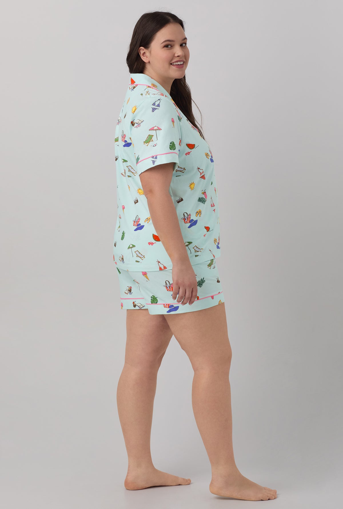 A lady wearing blue short sleeve classic shorty stretch jersey plus size pj set with beach day print