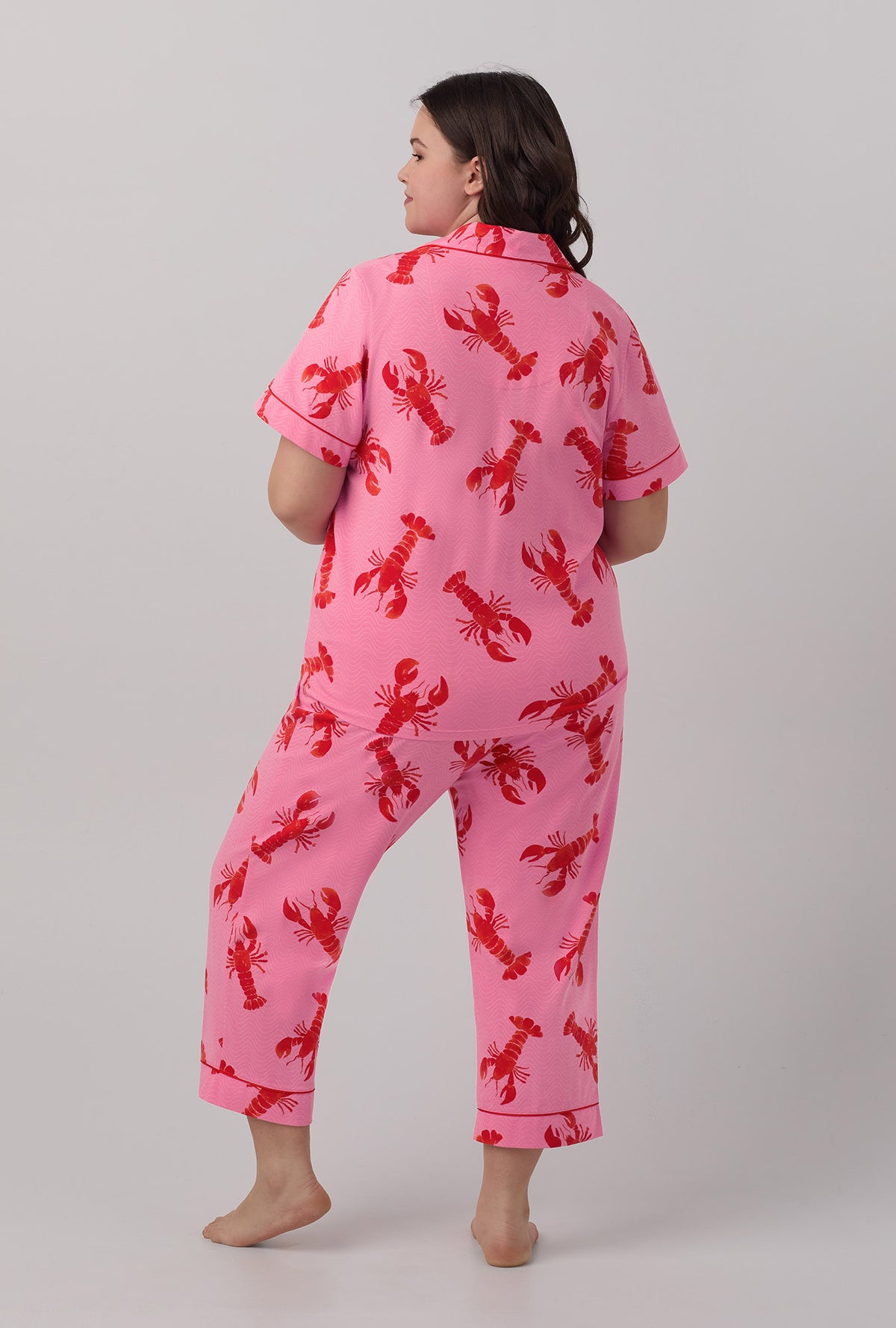 A lady wearing plus size  pink  Short Sleeve Classic Stretch Jersey Cropped PJ Set with Lobster Fest print.