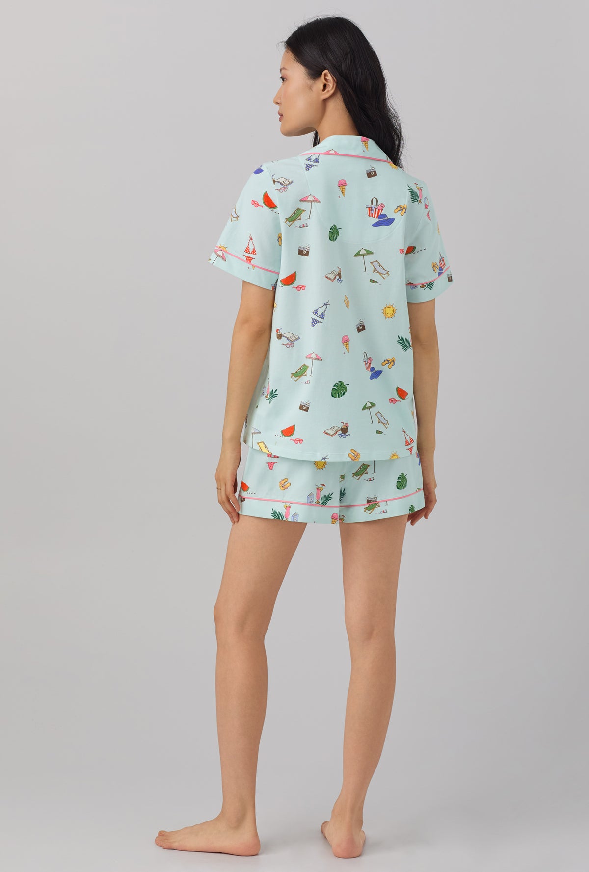 A lady wearing blue short sleeve classic shorty stretch jersey pj set with beach day print