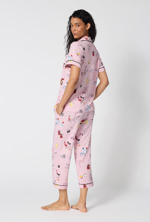A Lady Wearing J'adore Paris Short Sleeve Classic Stretch Jersey Cropped Pj Set in a side pose with both hands placed inside of the pockets