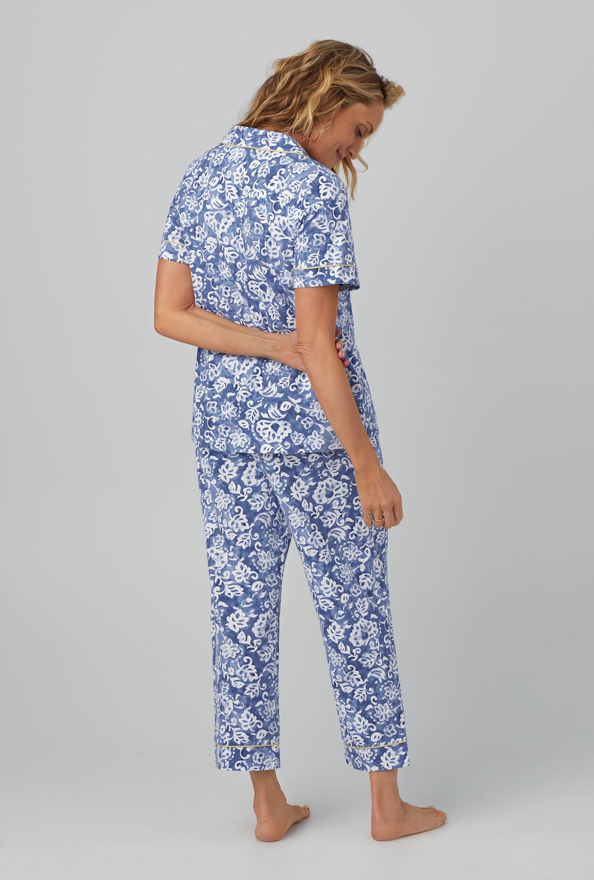 A lady wearing Short Sleeve Classic Stretch Jersey Cropped PJ Set with autumn eve print