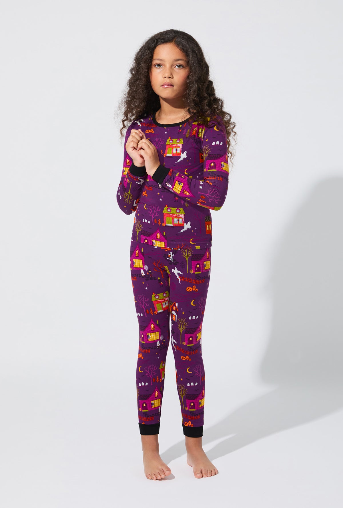A girl wearing Spooky Town USA Long Sleeve Stretch Jersey Kids PJ Set