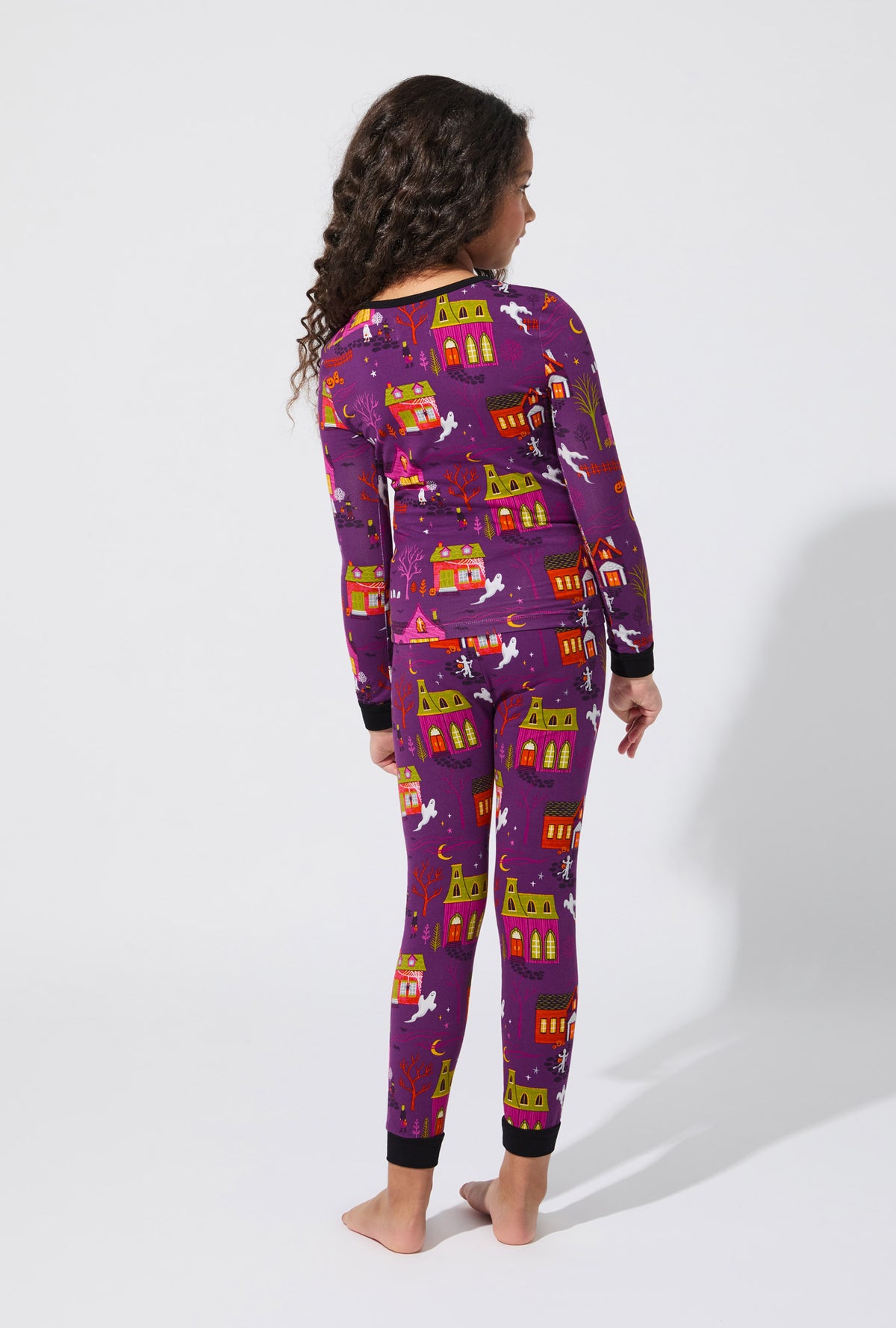 A girl wearing Spooky Town USA Long Sleeve Stretch Jersey Kids PJ Set