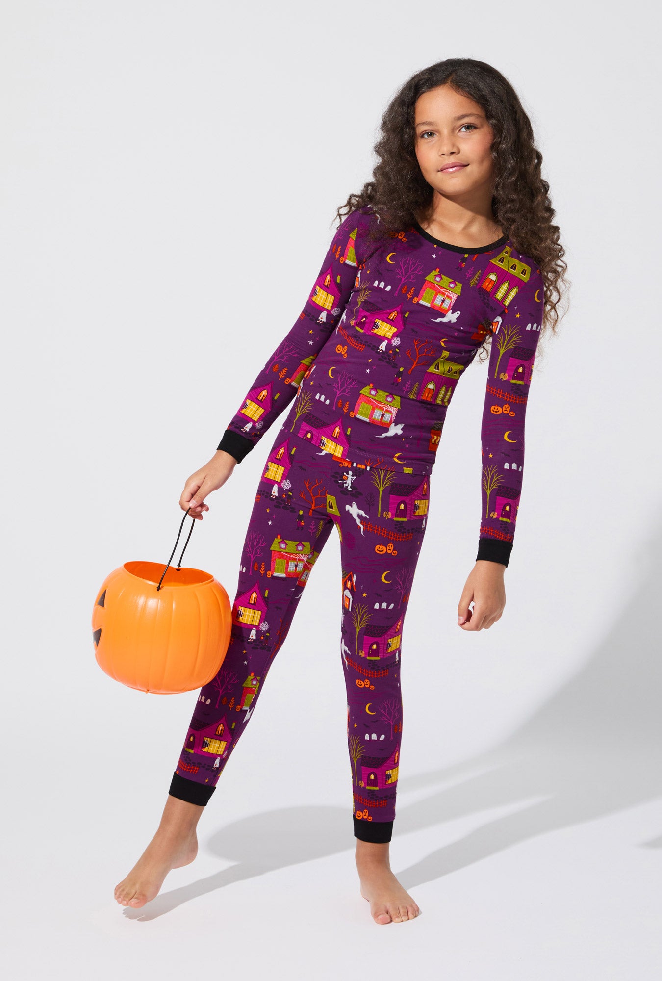 A girl wearing Spooky Town USA Long Sleeve Stretch Jersey Kids PJ Set