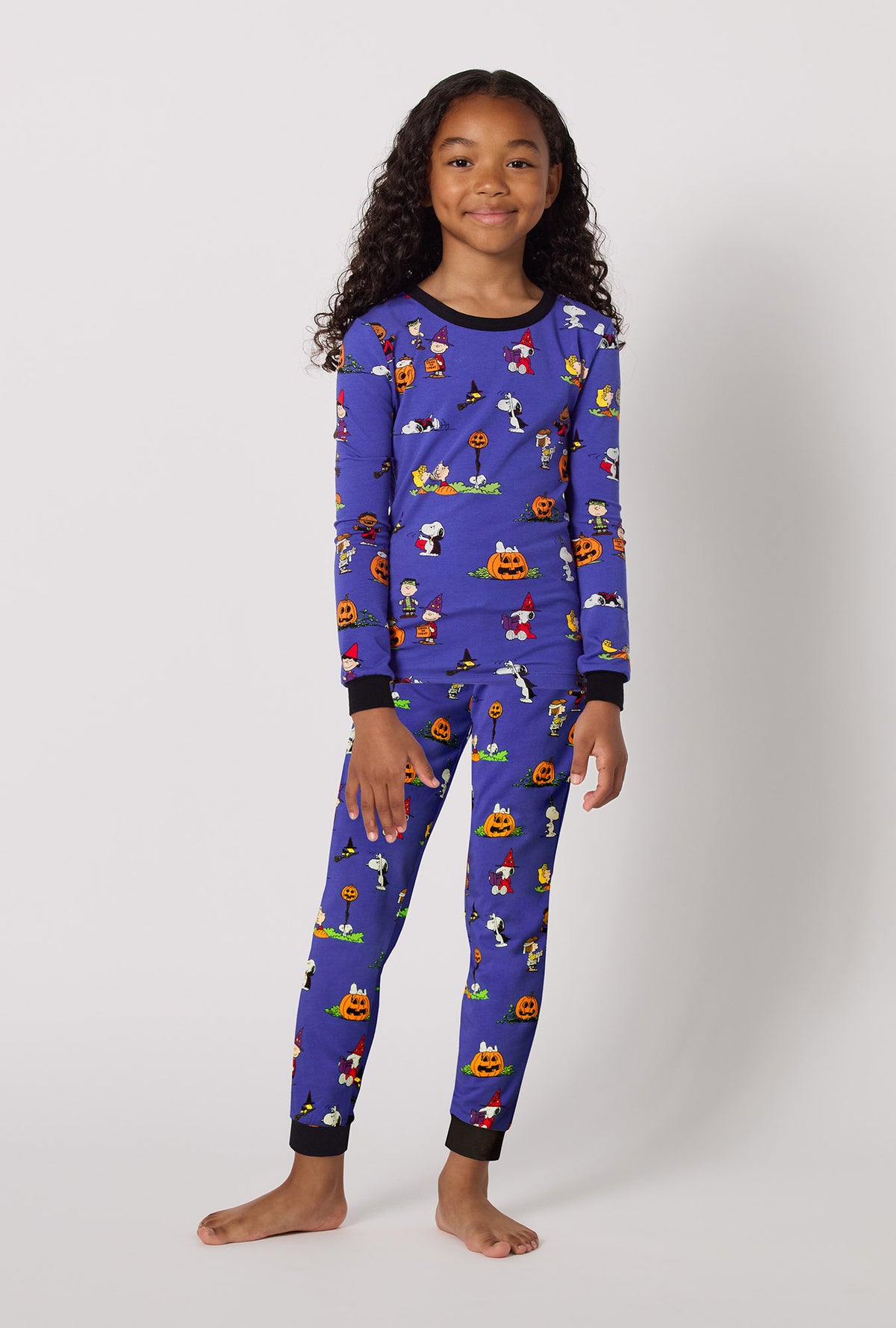 A Girl Wearing Spooky Season Snoopy Long Sleeve Stretch Jersey Kids Pj Set