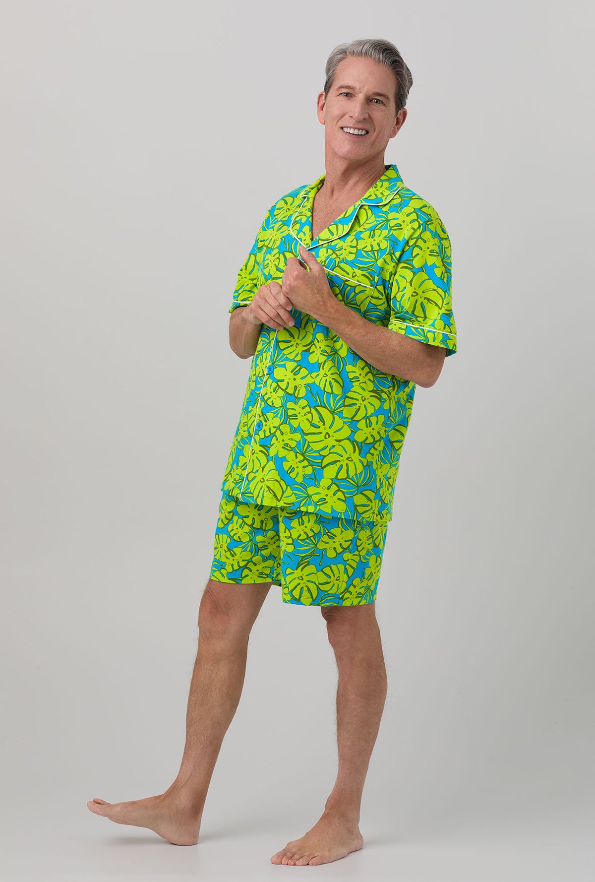 A man wearing Short Sleeve Notch Stretch Jersey Short PJ Set with palm leaves print