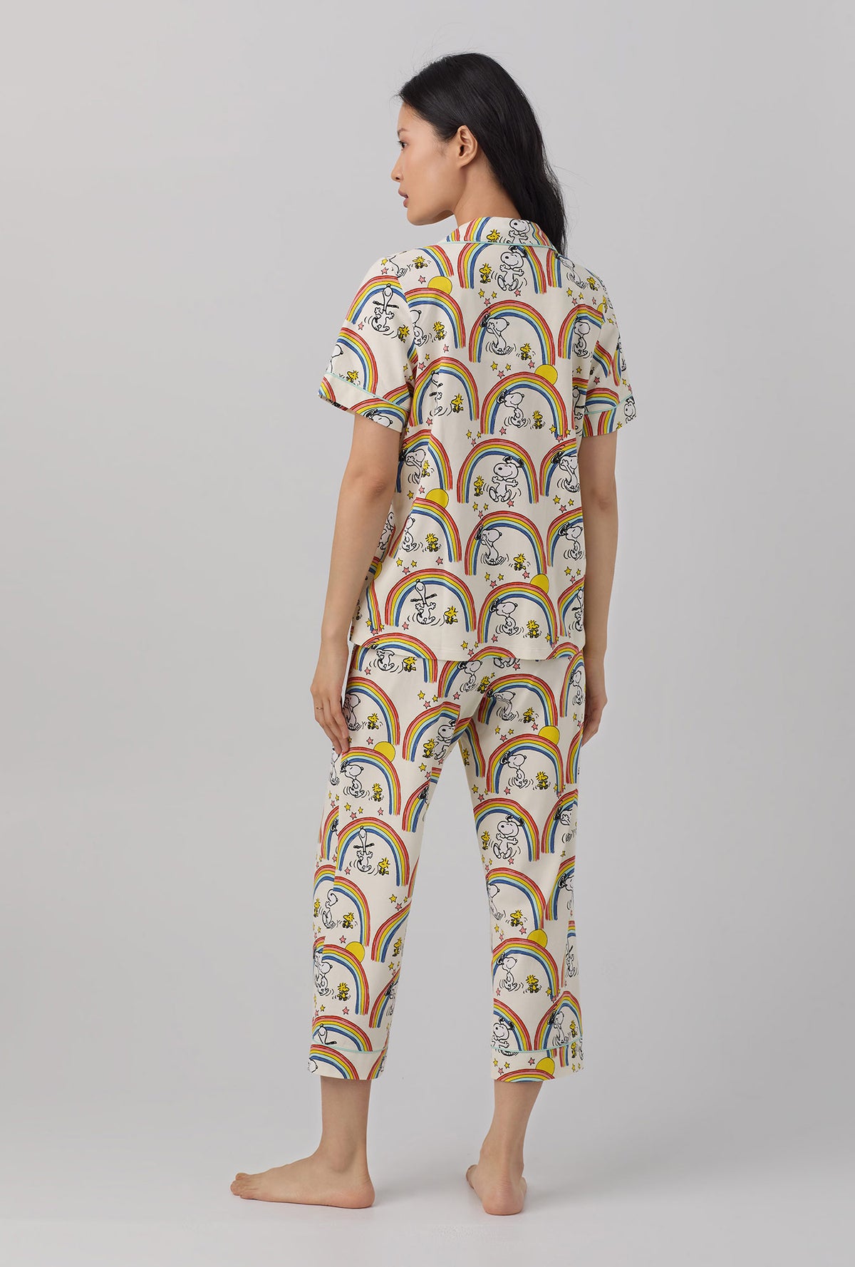 A lady wearing white Short Sleeve Classic Stretch Jersey Cropped PJ Set  with Sunshine Snoopy print.