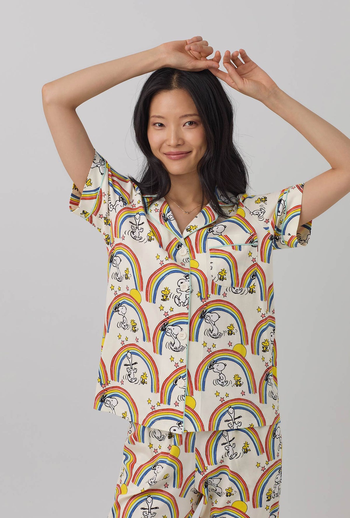 A lady wearing white Short Sleeve Classic Stretch Jersey Cropped PJ Set  with Sunshine Snoopy print.