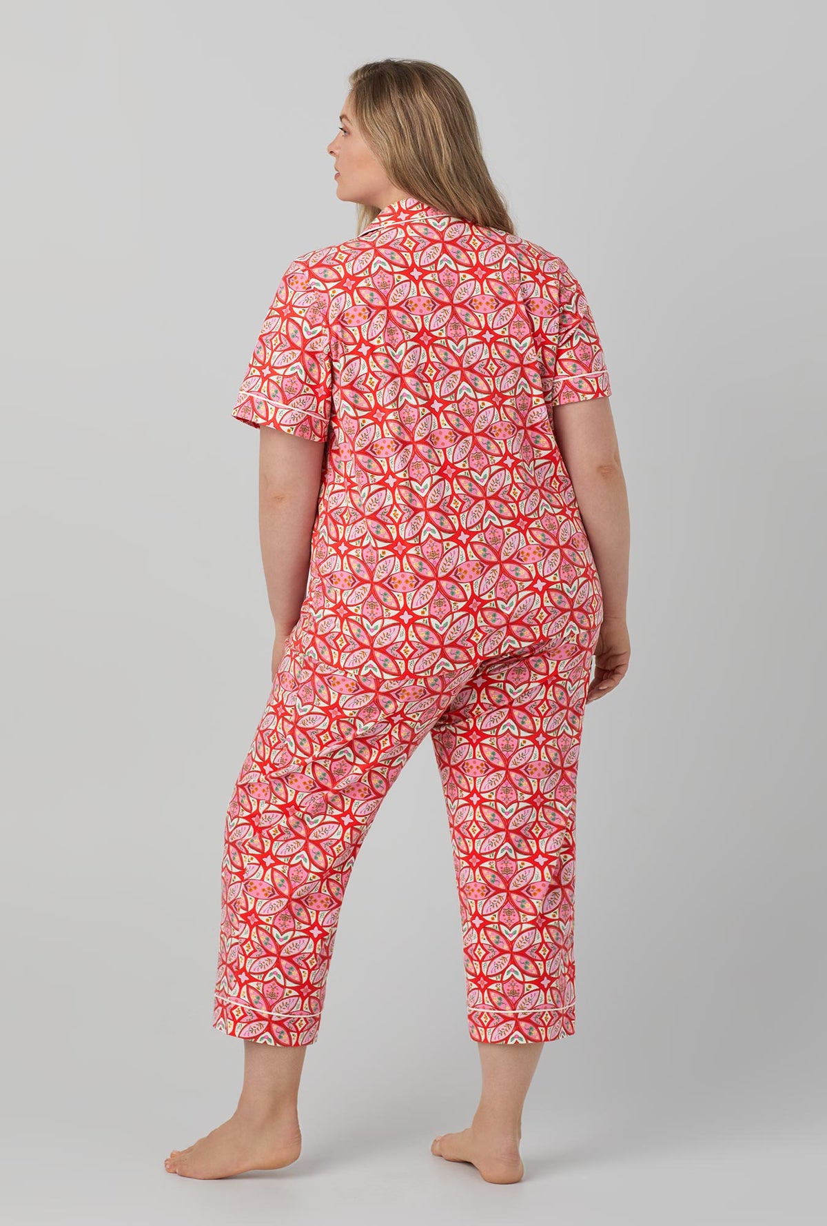 A lady wearing red Short Sleeve Classic Stretch Jersey Cropped PJ Set with Prairie Dawn print