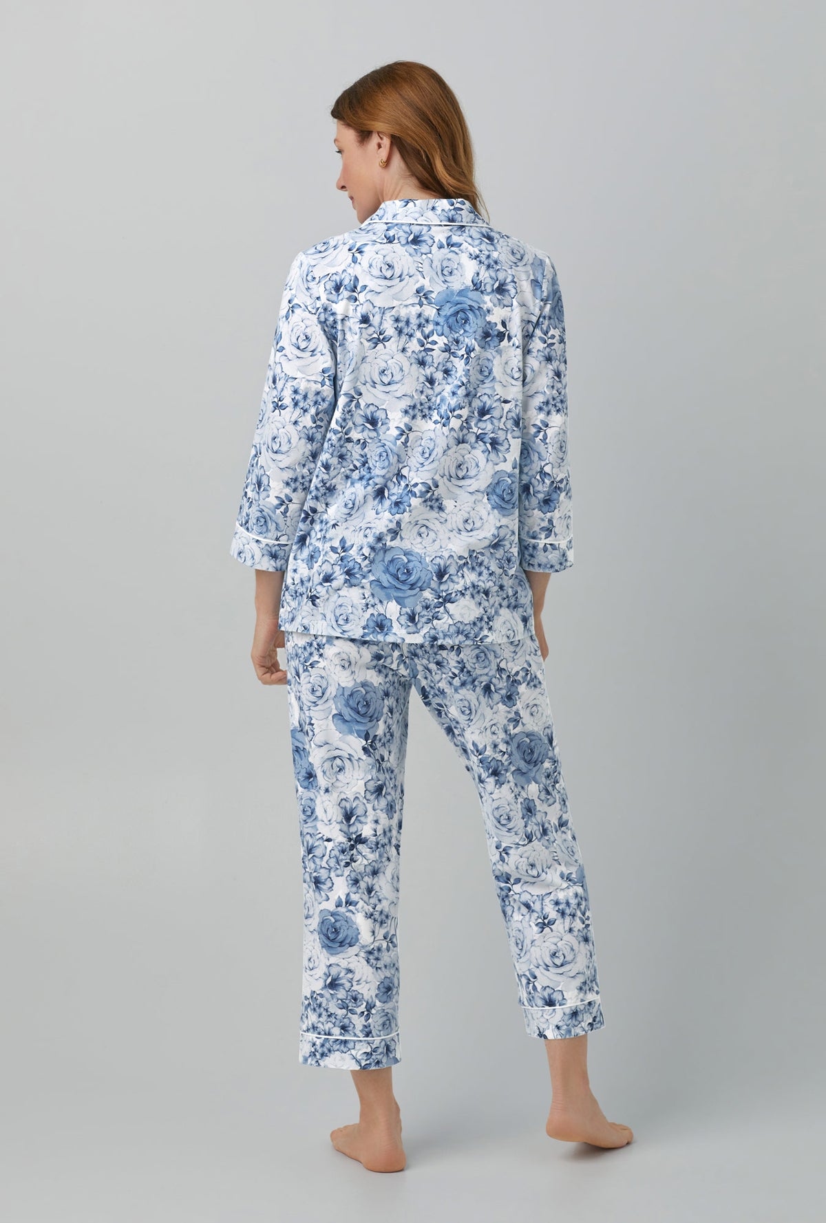 A lady wearing blue quarter sleeve classic stretch jersey cropped pj set with eternal blooms print.