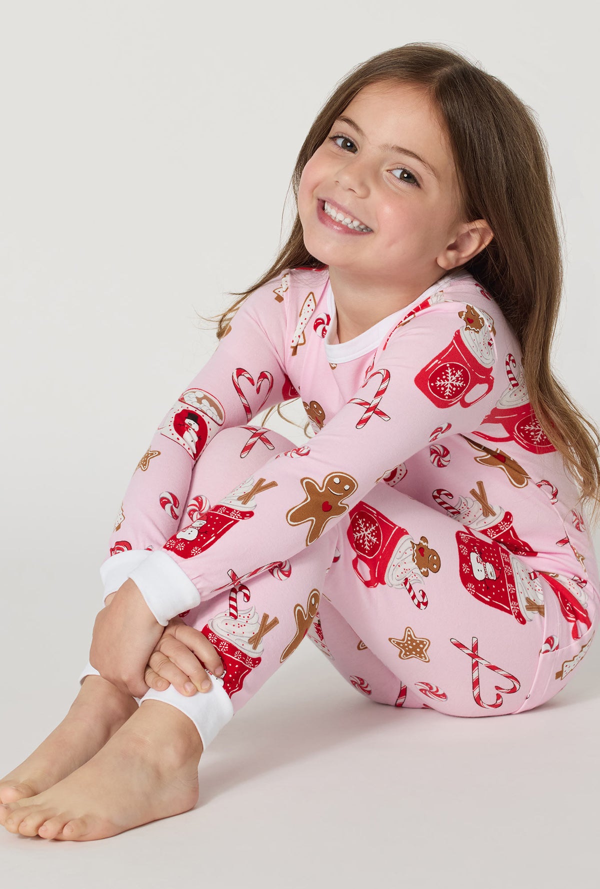 A Girl wearing Candy And Cocoa Long Sleeve Stretch Jersey Kids Pj Set sitting down