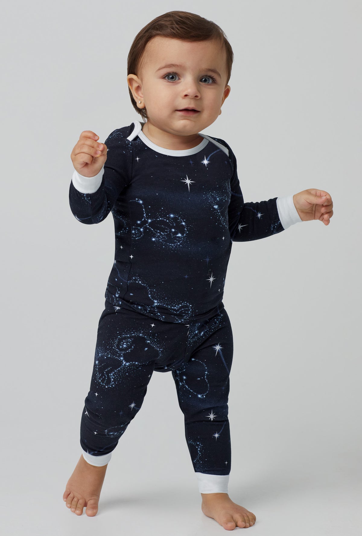 A baby wearing black long sleeve stretch jersey boo boo pj set with celestial snoopy print.