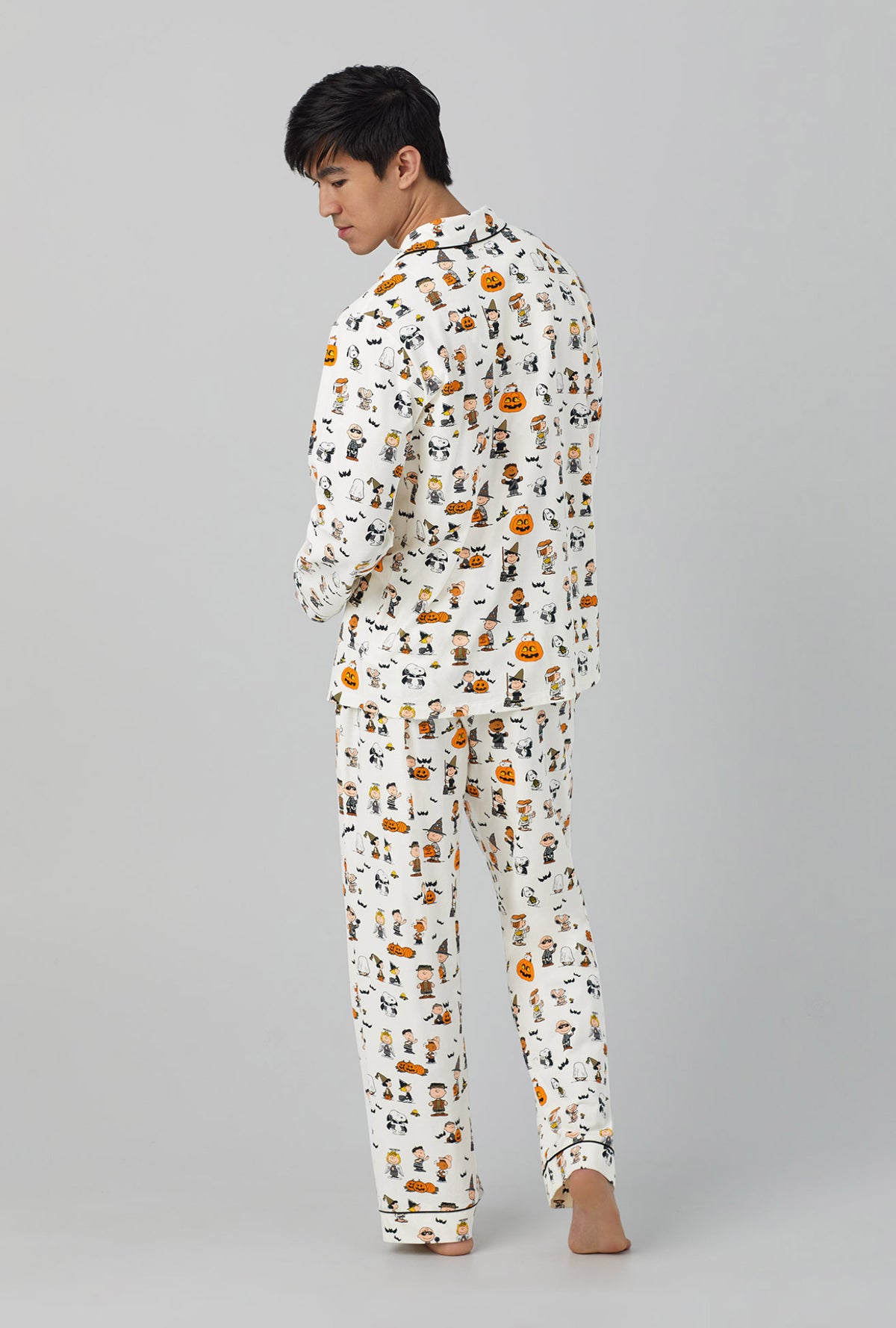 A man wearing white long sleeve classic stretch jersey pj set with snoopys halloween print