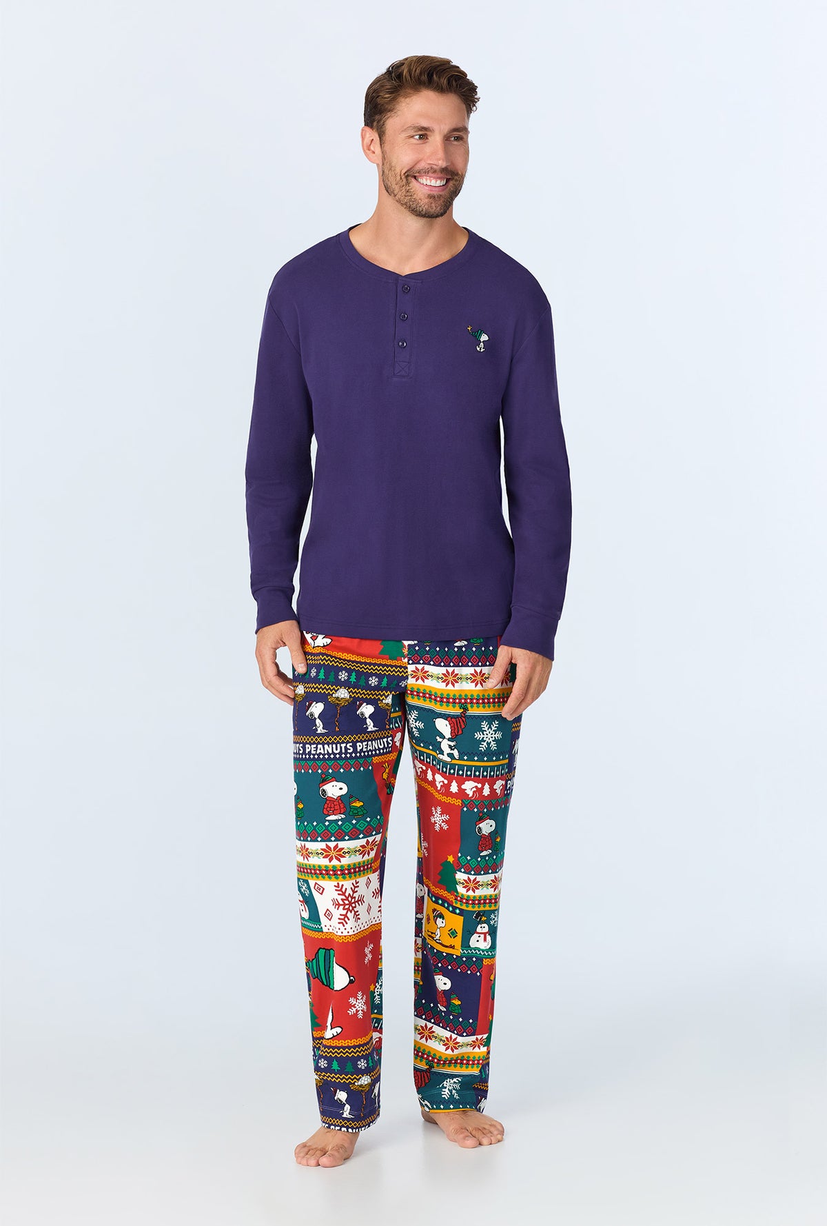 A man wearing Fairisle Snoopy® Men&#39;s Long Sleeve Henley Stretch Jersey PJ Set