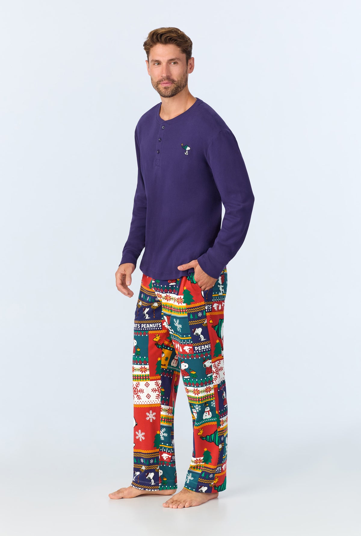 A man wearing Fairisle Snoopy® Men&#39;s Long Sleeve Henley Stretch Jersey PJ Set