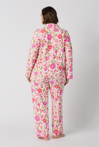 A Lady Wearing Plus Size Josephine Long Sleeve Classic Stretch Jersey Pj Set facing back in a full standing pose
