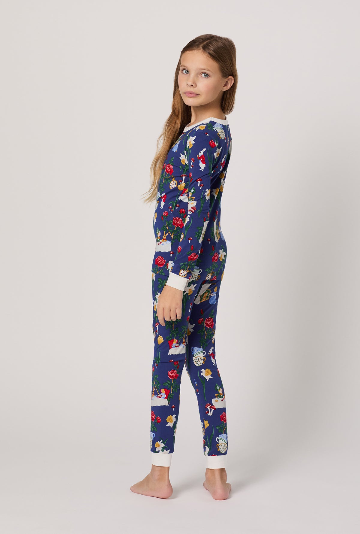 A girl wearing Alice's Adventures Long Sleeve Stretch Jersey Kids Pj Set