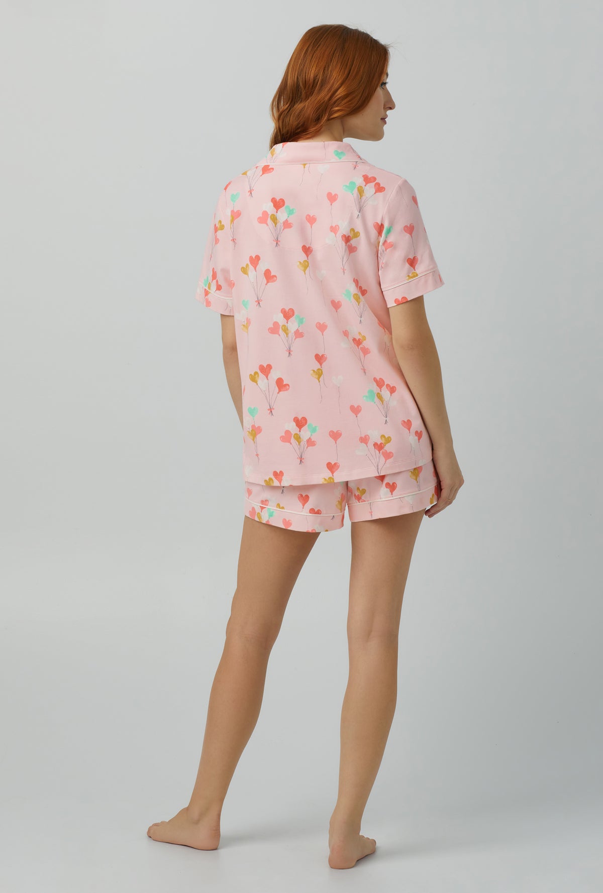 A lady wearing Short Sleeve Classic Shorty Stretch Jersey PJ Set with Floating Hearts