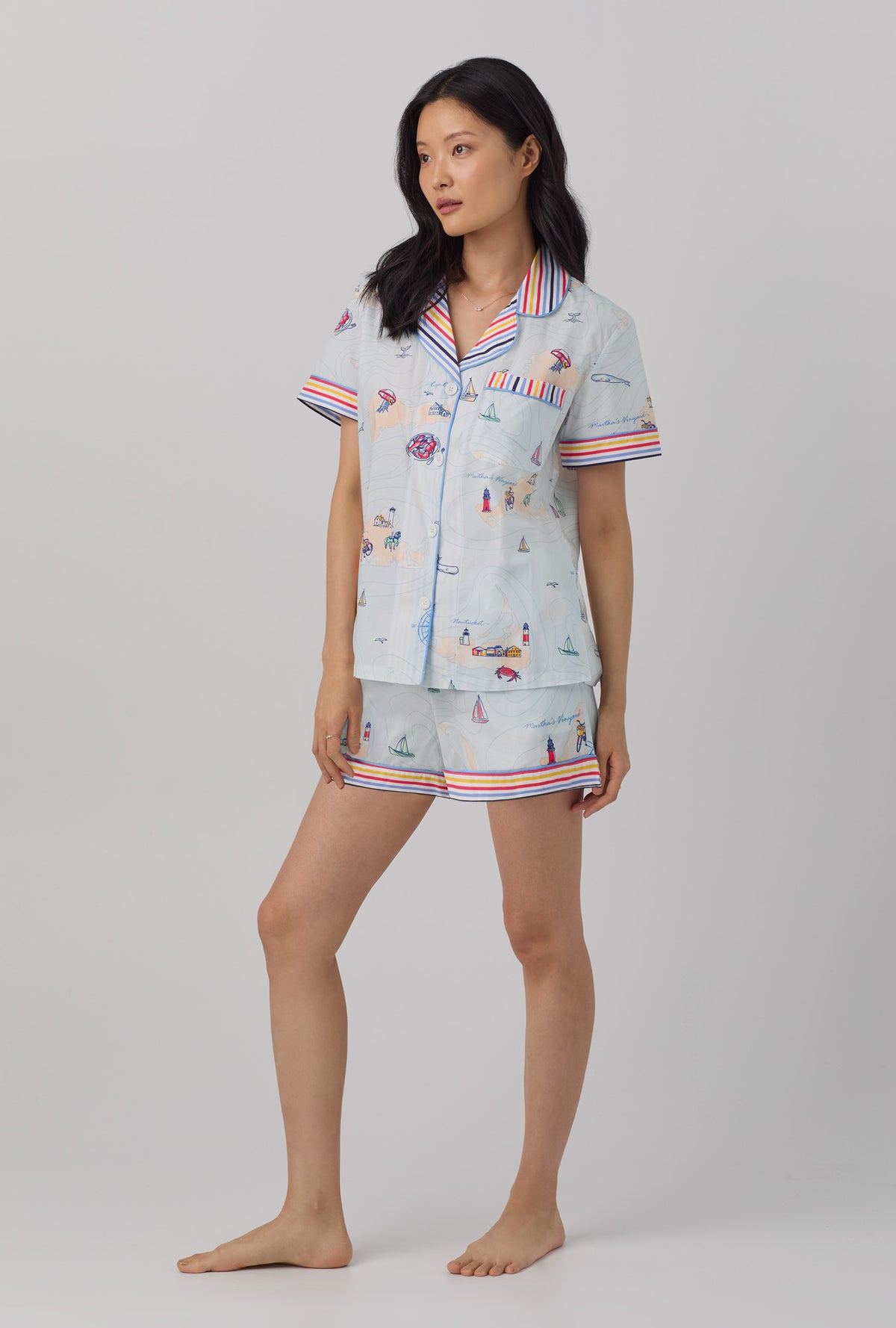 A lady wearing multi color short sleeve classic shorty woven cotton poplin  pj set with eastern seaboard print.