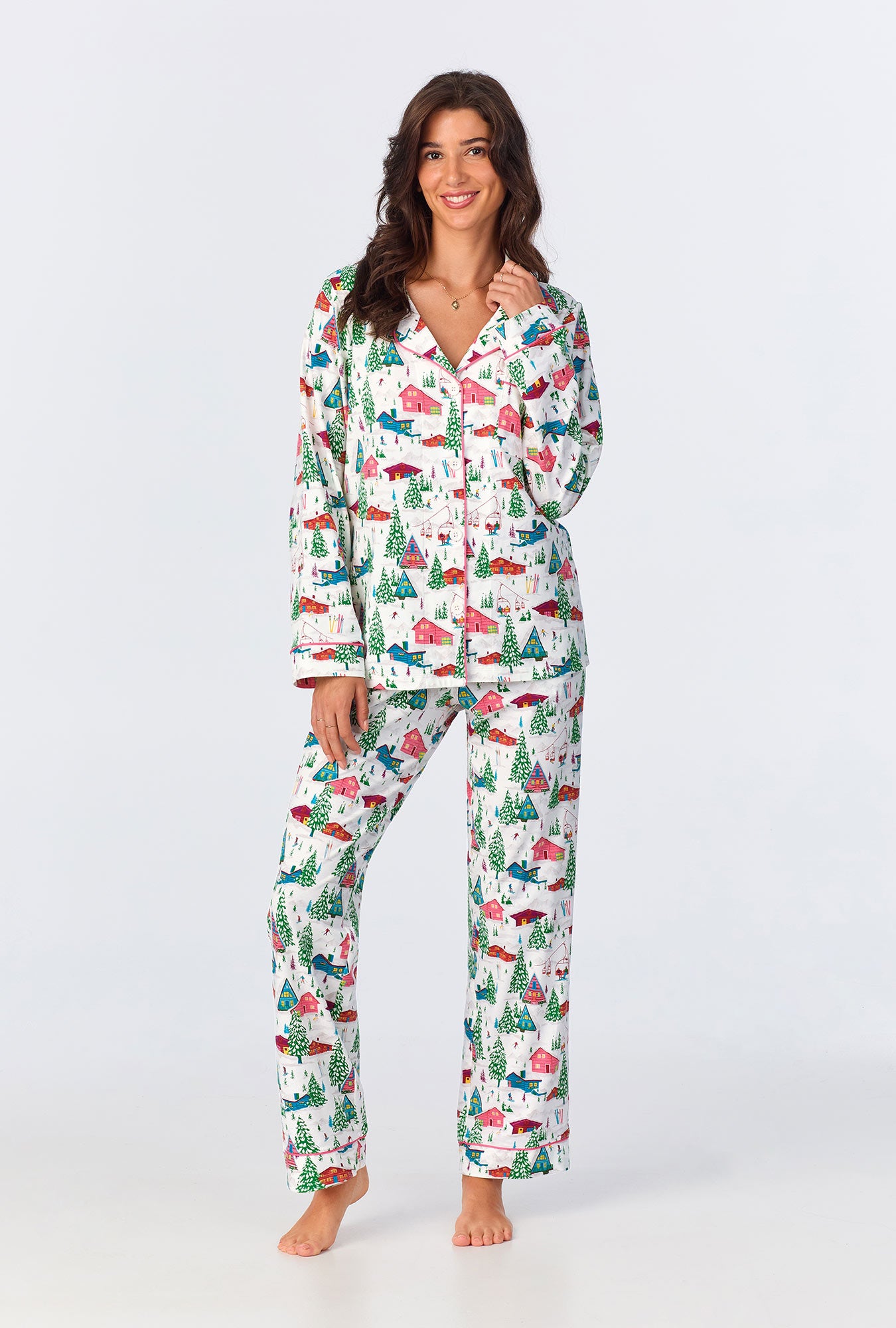 A lady wearing white long sleeve pullover  crew jogger stretch jersey pj set with alpine cabins print.