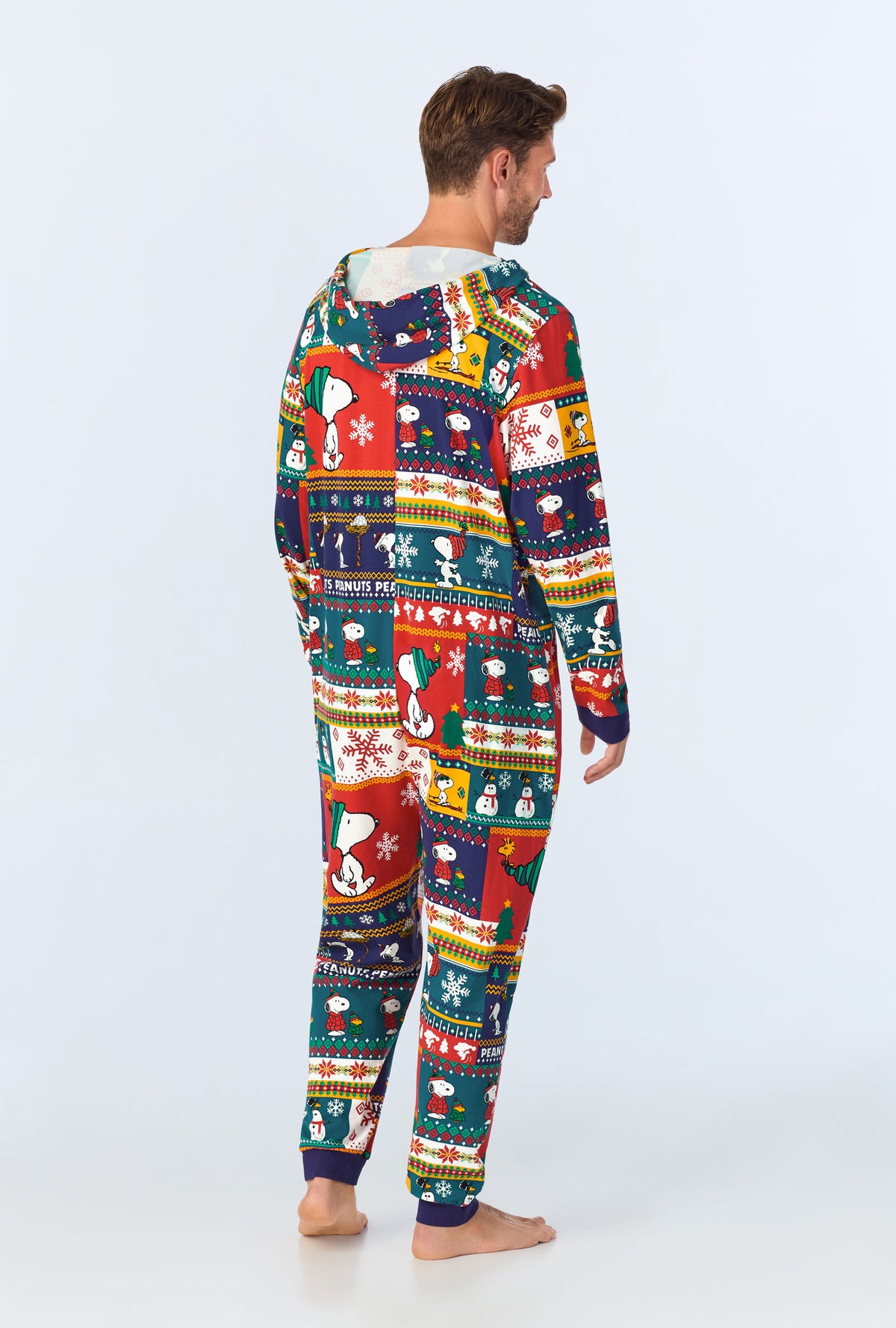 A man wearing fairisle snoopy long sleeve onesie