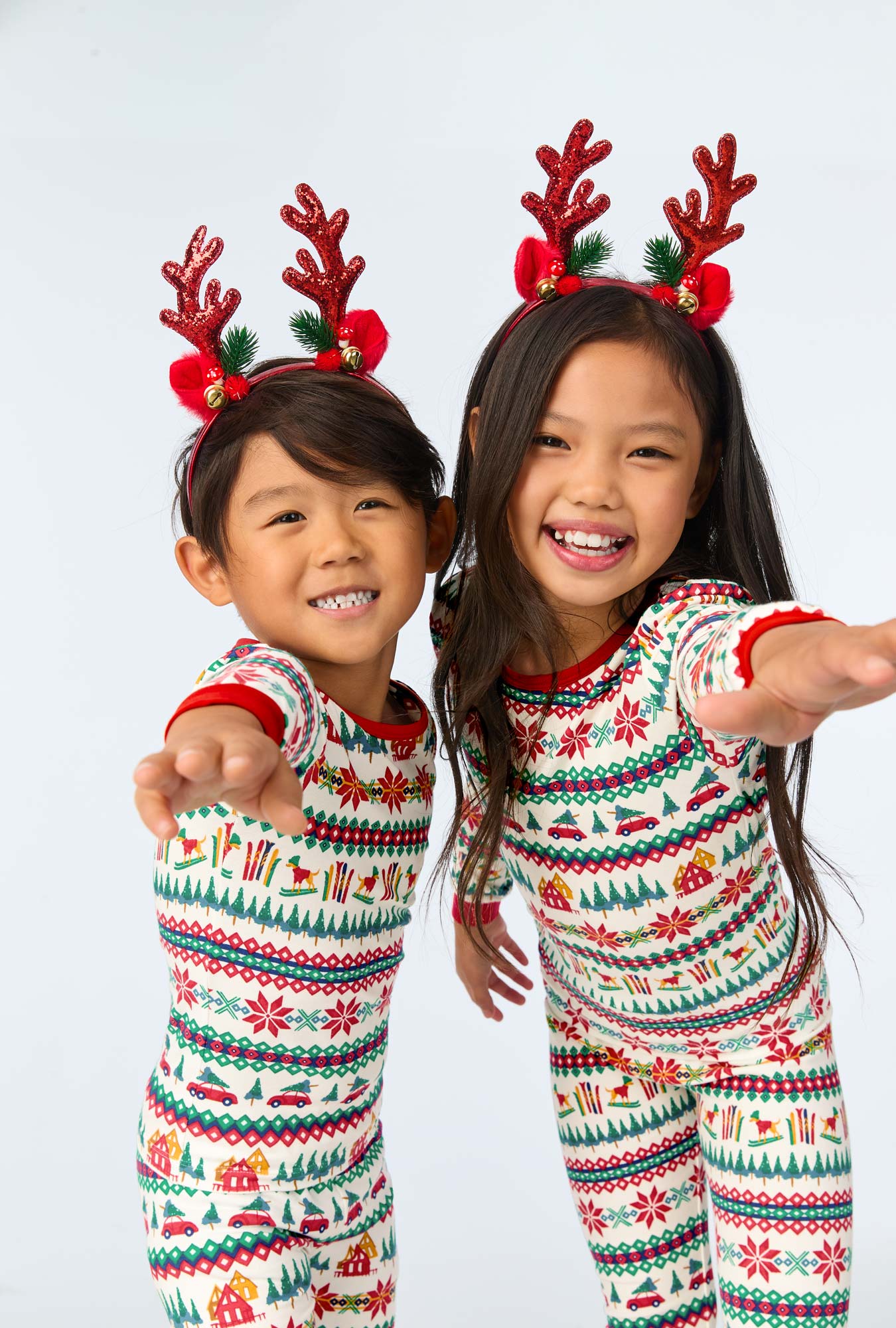 Two children wearing Festive Fairisle Long Sleeve Stretch Jersey Kids PJ Set