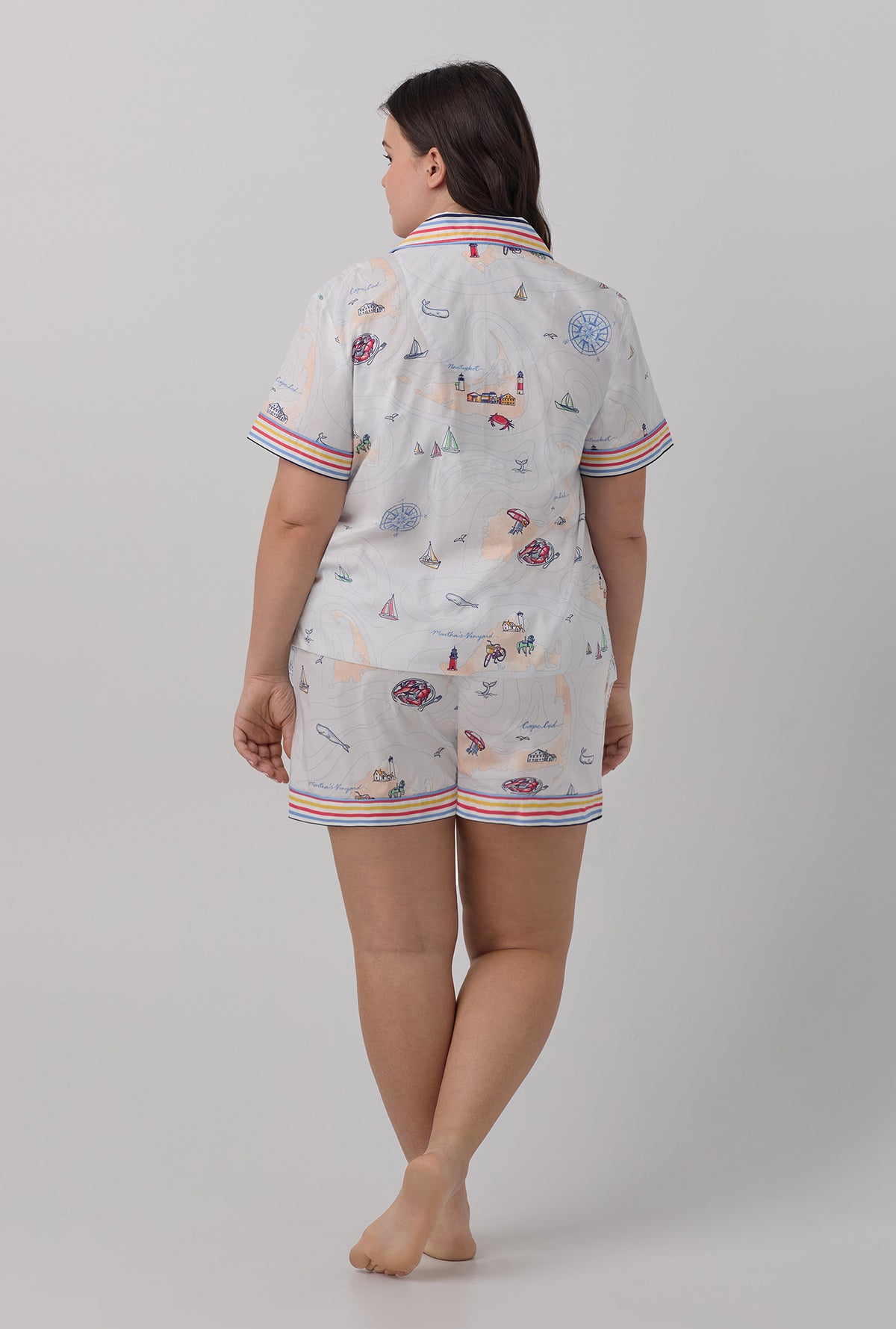 A lady wearing multi color short sleeve classic shorty woven cotton poplin  plus size pj set with eastern seaboard print.