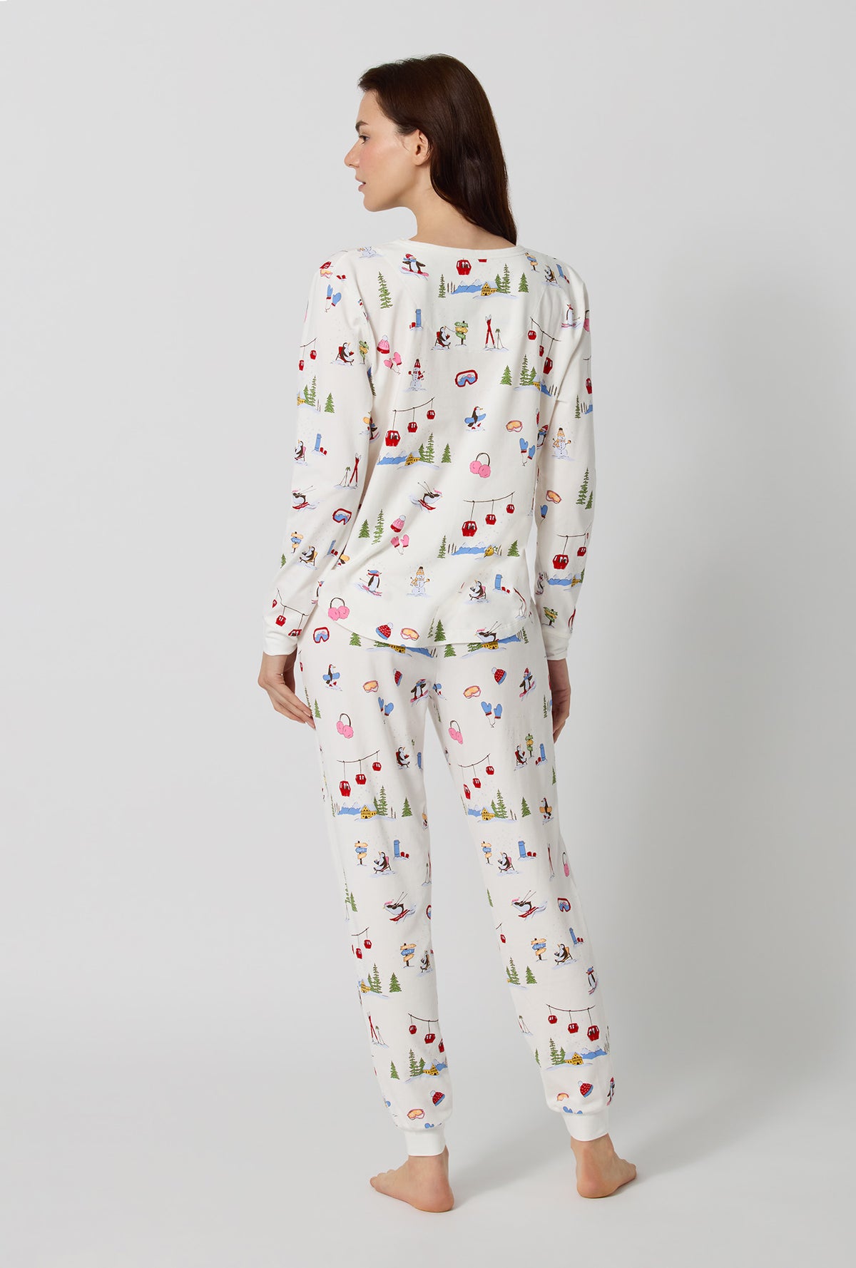 A lady wearing Snow Much Fun Long Sleeve Pullover Crew And Jogger Stretch Jersey Pj Set back view
