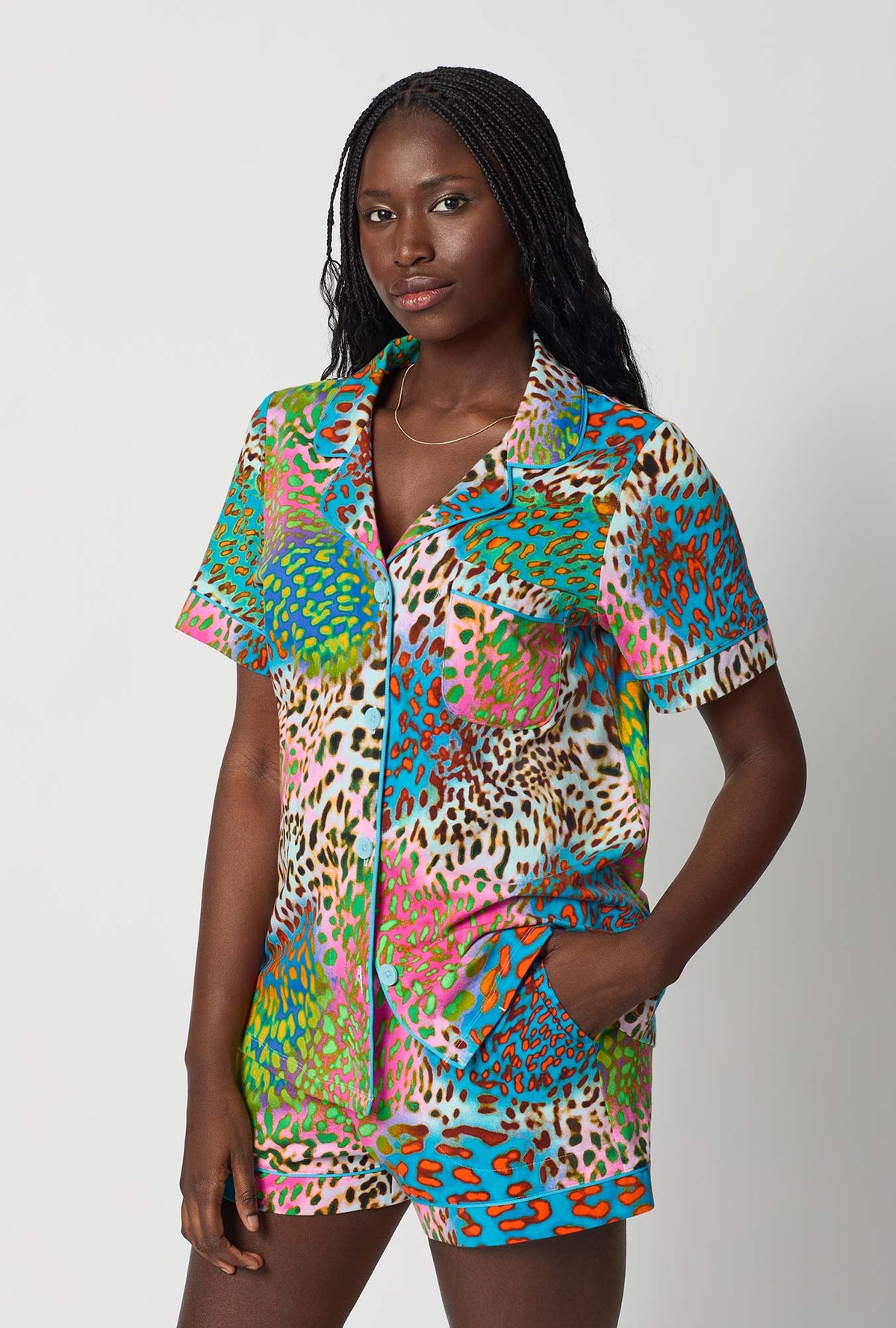 A lady wearing BedHead x Trina Turk Spray Leopard Short Sleeve Classic Shorty Stretch Jersey Pj Set