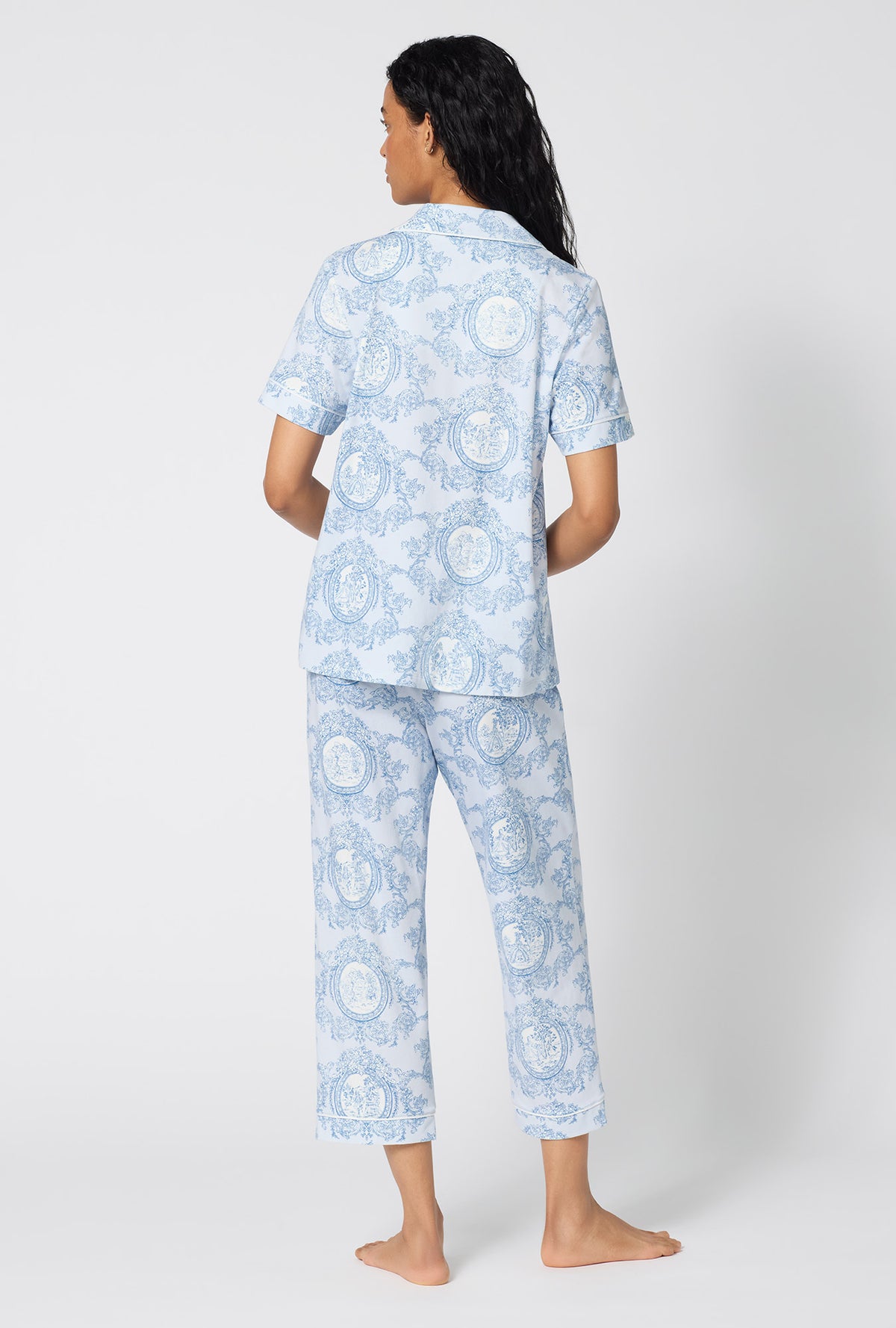 A Lady Wearing Minuet Toile Short Sleeve Classic Stretch Jersey Cropped Pj Set posing in a full back view pose
