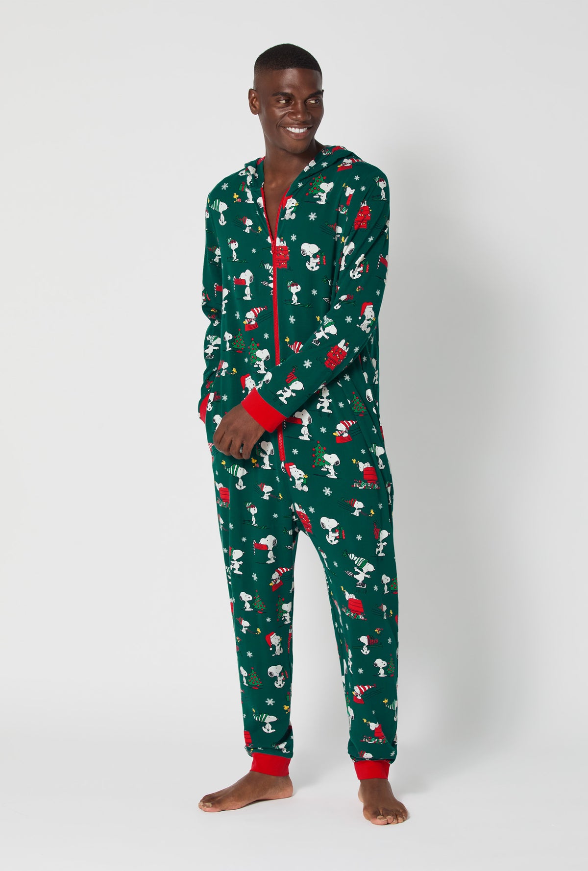 A man wearing ®Snoopy's Holiday Fun Long Sleeve Stretch Jersey Unisex Onesie