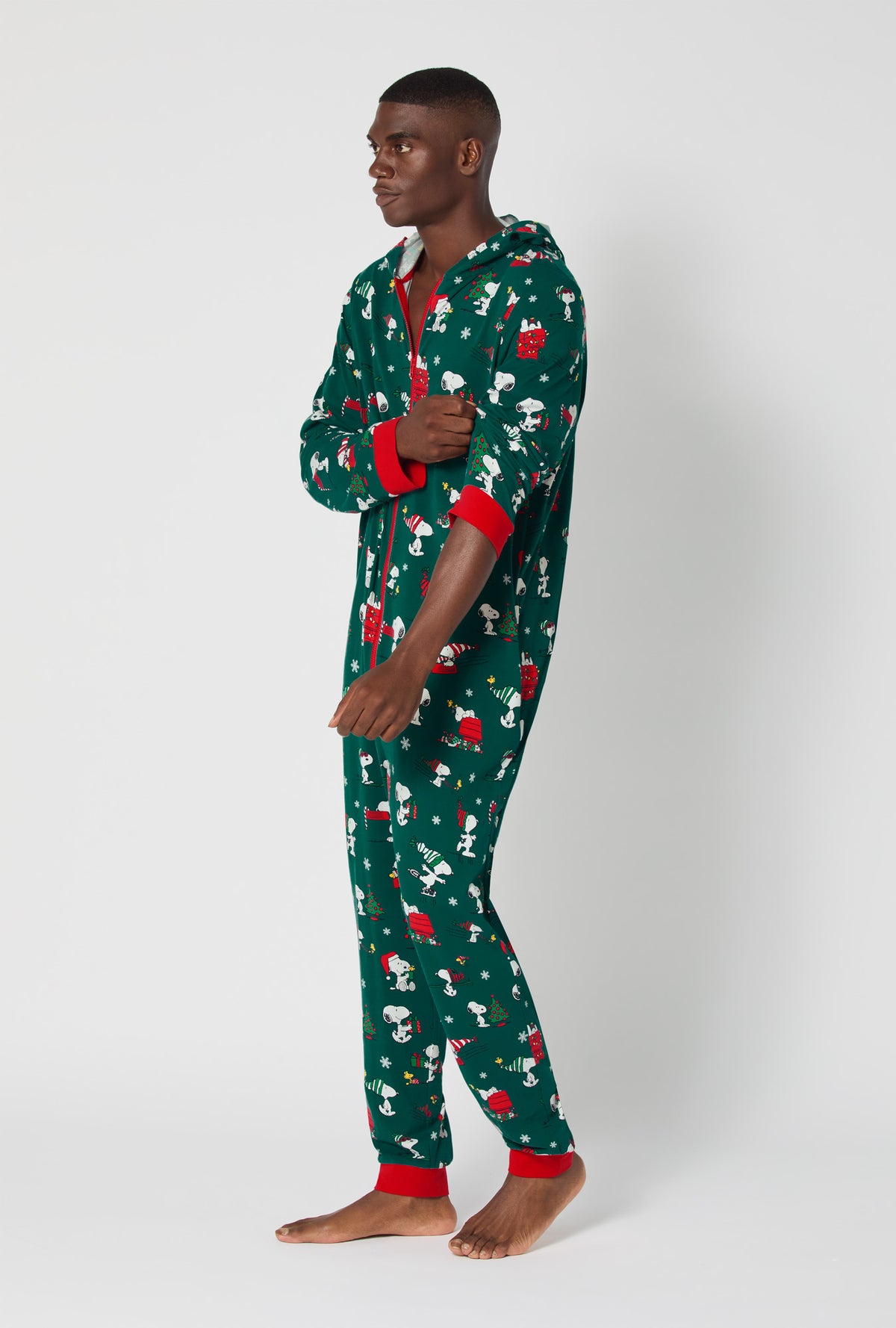 A man wearing ®Snoopy's Holiday Fun Long Sleeve Stretch Jersey Unisex Onesie