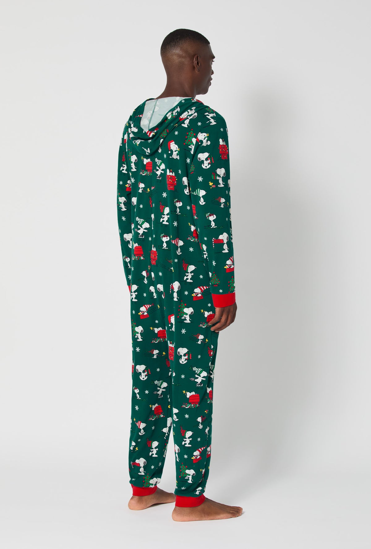 A man wearing ®Snoopy's Holiday Fun Long Sleeve Stretch Jersey Unisex Onesie