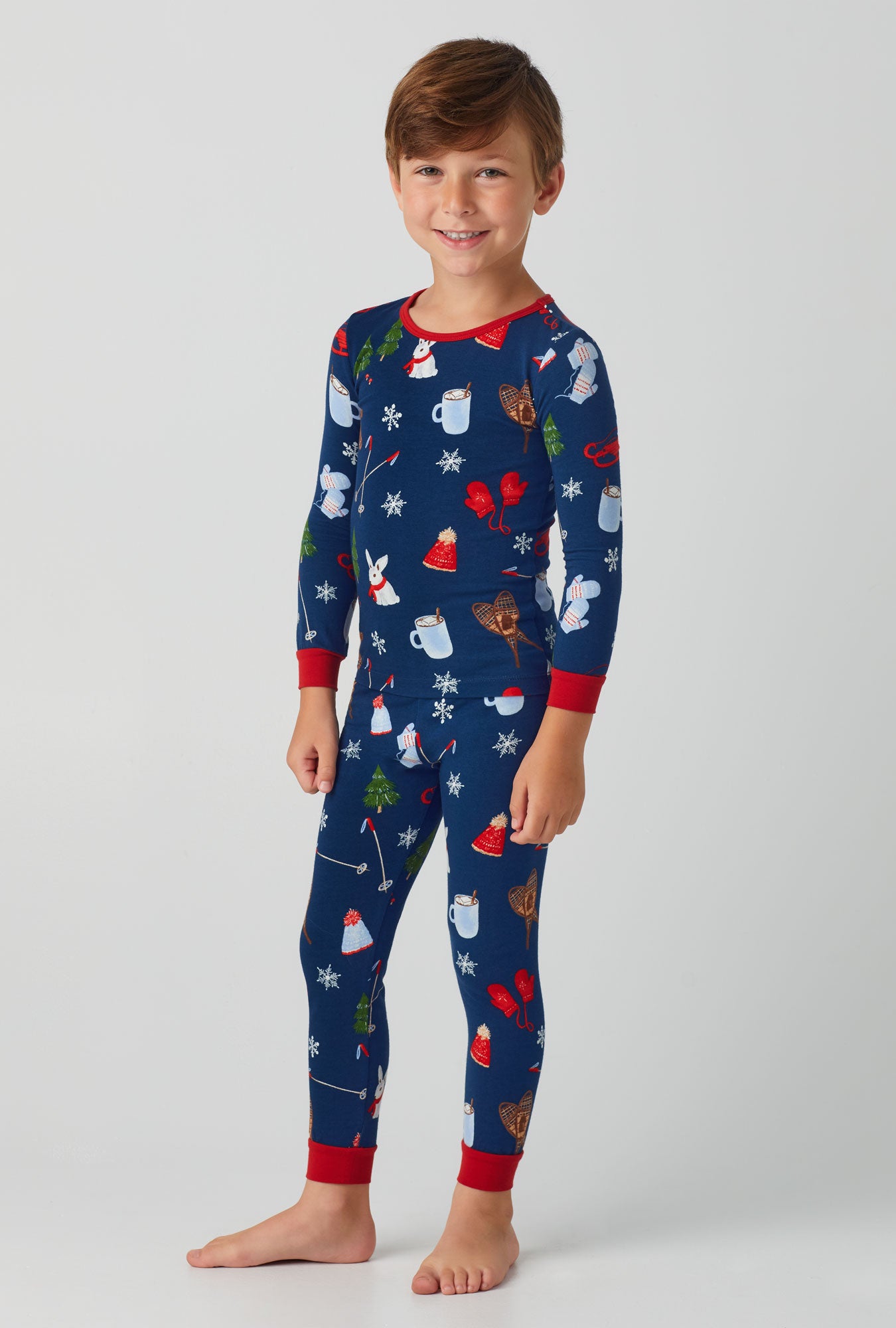 A boy wearing blue Long Sleeve Stretch Jersey Kids PJ Set with Seasonal Delights print