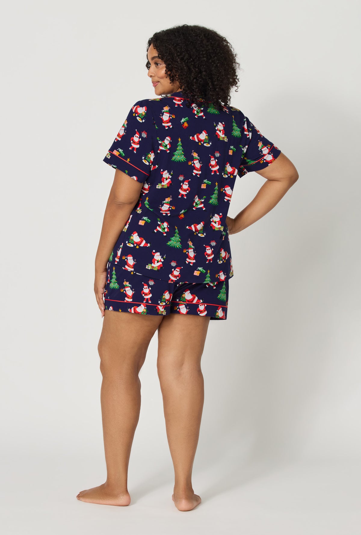 A lady wearing plus size Santa's Night Out Short Sleeve Classic Shorty Stretch Jersey Pj Set back view
