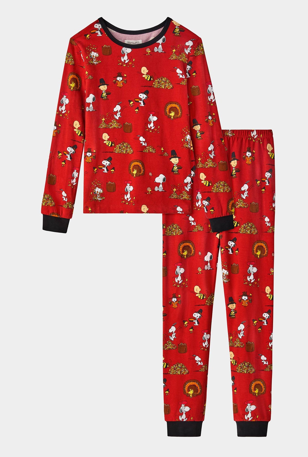 A girl wearing Peanuts® Snoopy&#39;s Thanksgiving Long Sleeve Stretch Jersey Kids PJ Set