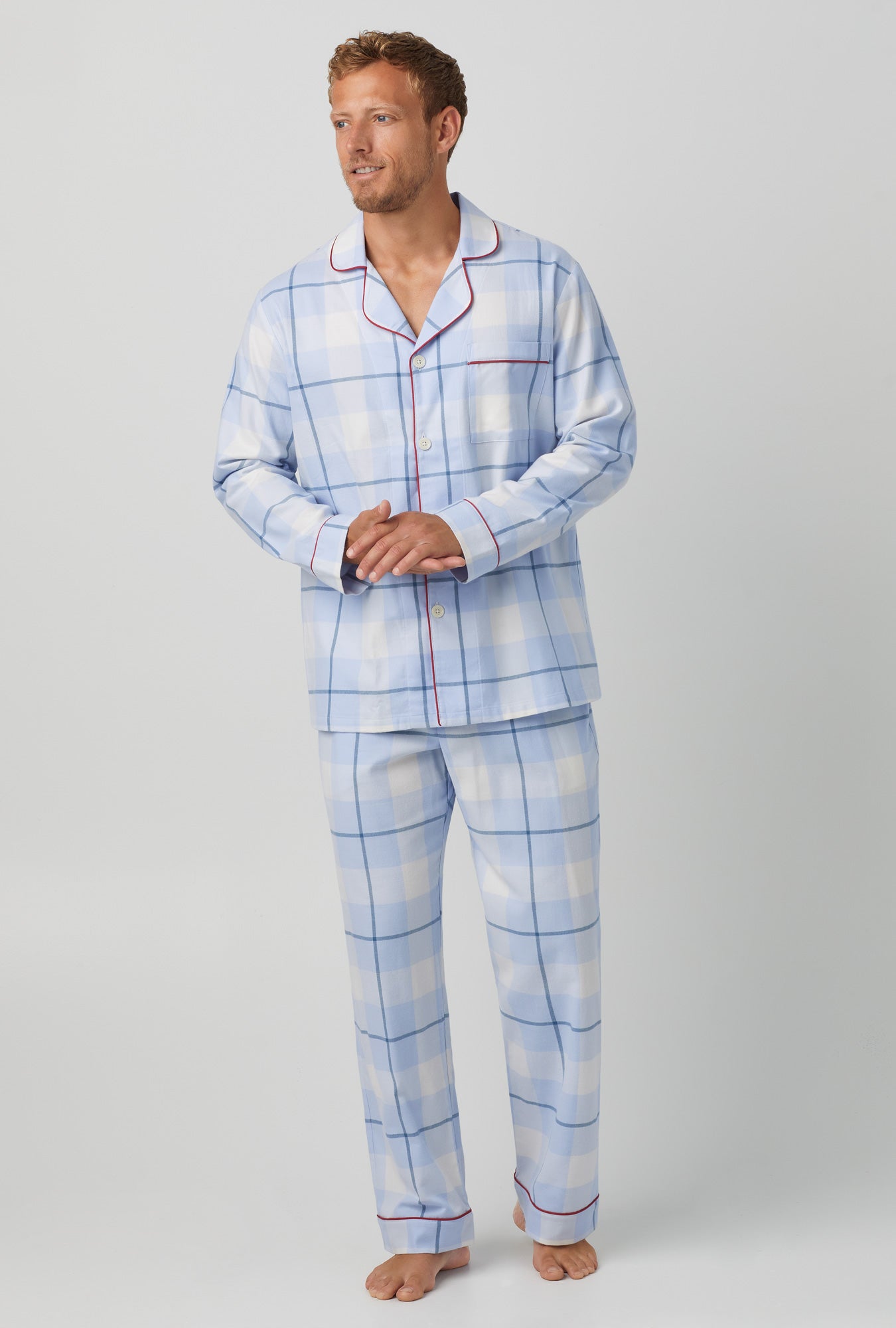 A man wearing blue long sleeve classic woven cotton portuguess flannel pj set with peaceful plaid print.