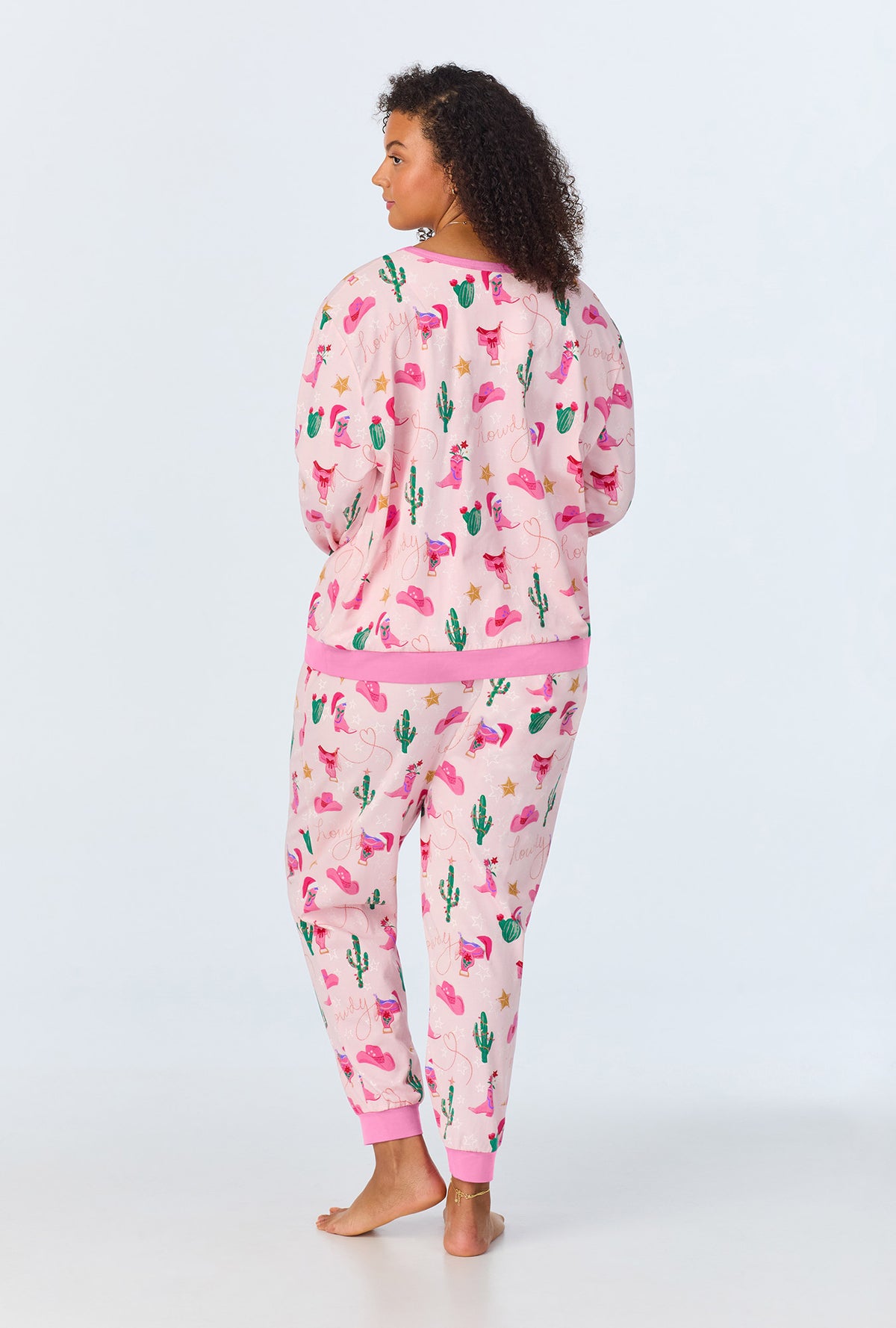 A lady wearing Christmas Cowgirl Long Sleeve Pullover Crew and Jogger Stretch Jersey PJ Set