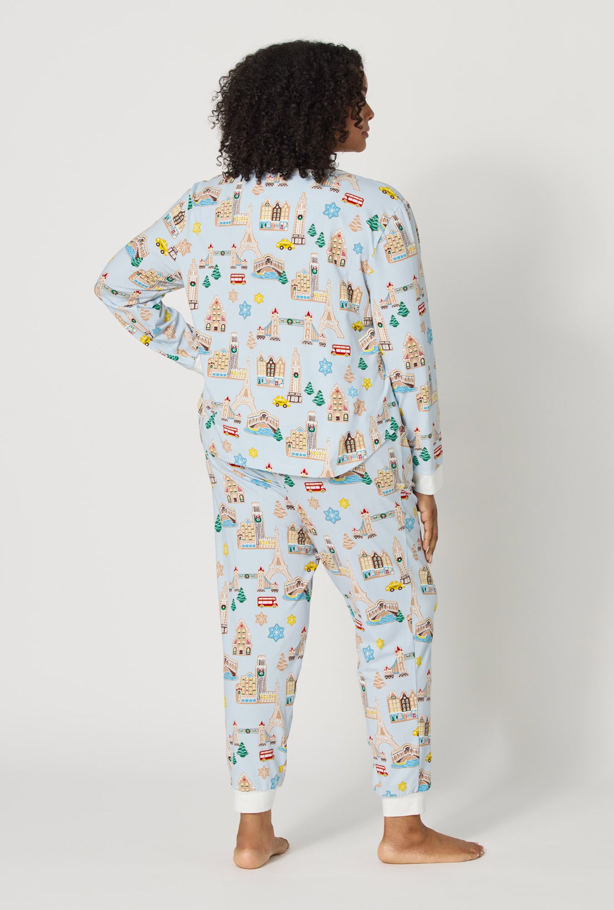 A lady wearing plus size Gingerbread City Long Sleeve Pullover Crew And Jogger Stretch Jersey Pj Set back view