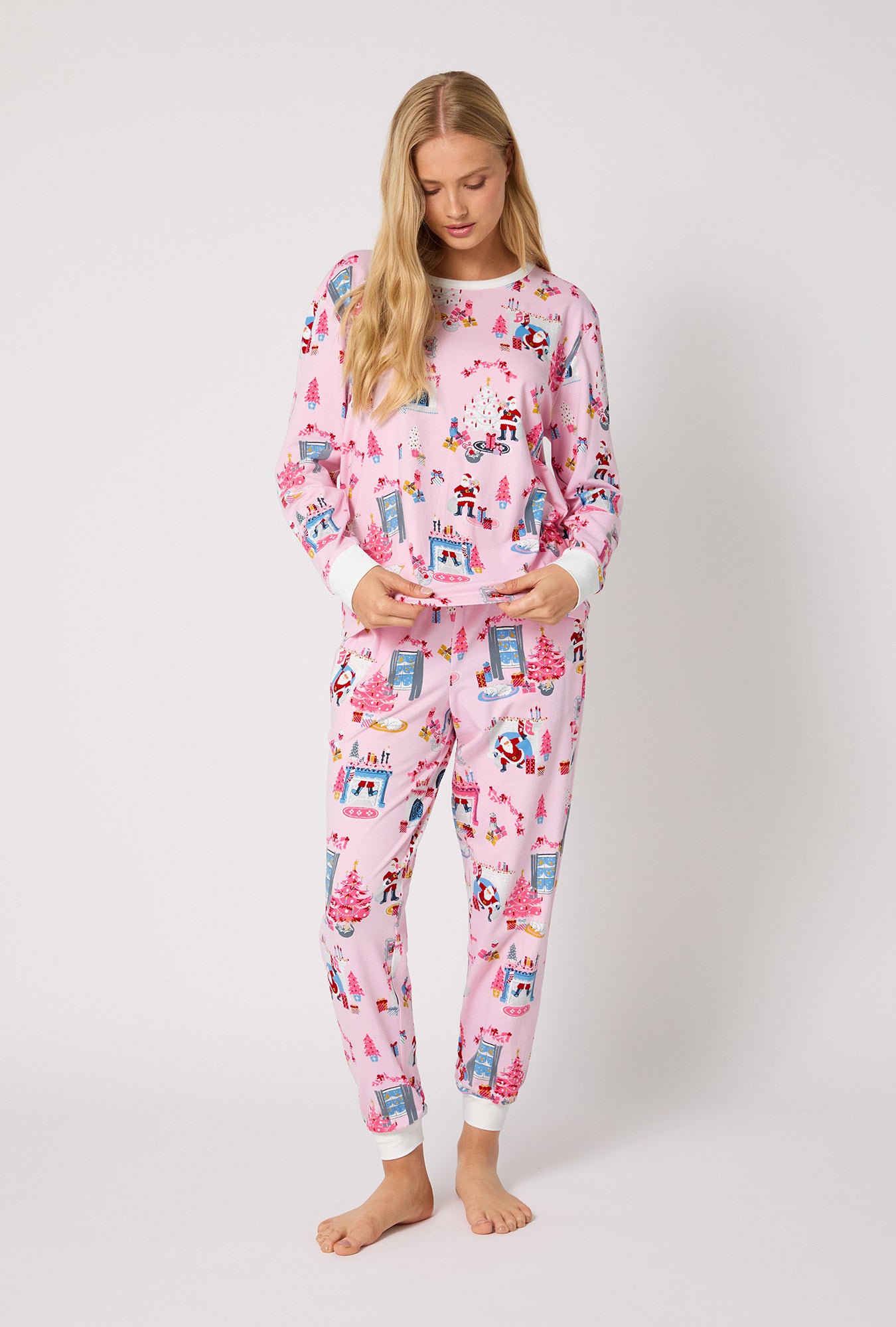 A lady wearing Must Be Santa Long Sleeve Pullover Crew And Jogger Stretch Jersey Pj Set