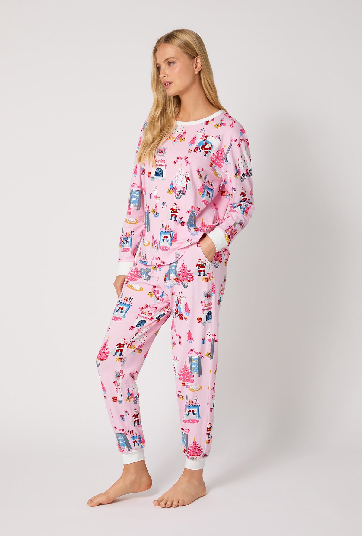 A lady wearing Must Be Santa Long Sleeve Pullover Crew And Jogger Stretch Jersey Pj Set
