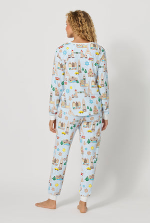 A lady wearing Gingerbread City Long Sleeve Pullover Crew And Jogger Stretch Jersey Pj Set back view