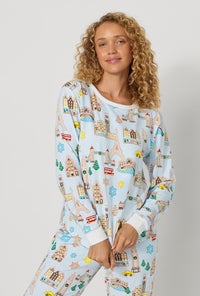 A lady wearing Gingerbread City Long Sleeve Pullover Crew And Jogger Stretch Jersey Pj Set closer look
