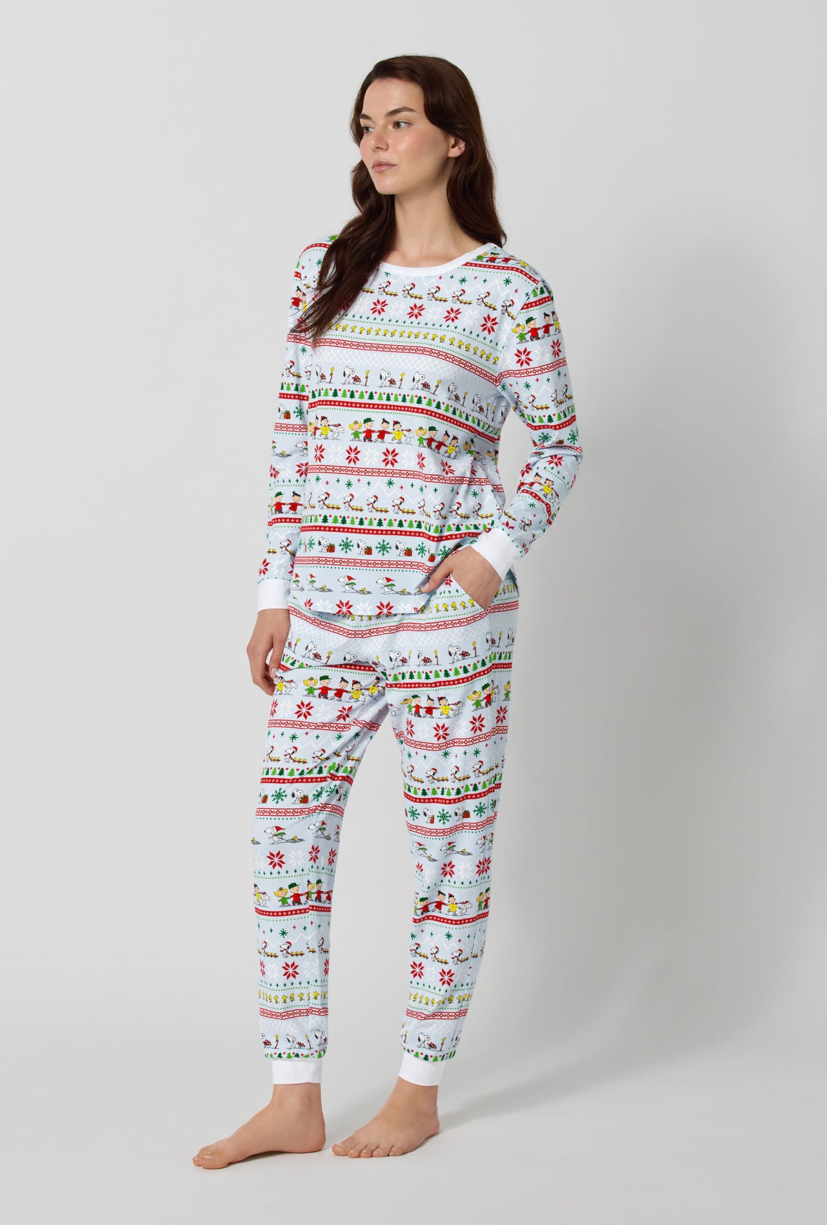 A lady wearing Peanuts® Winter Parade Long Sleeve Pullover Crew And Jogger Stretch Jersey Pj Set looking sdie