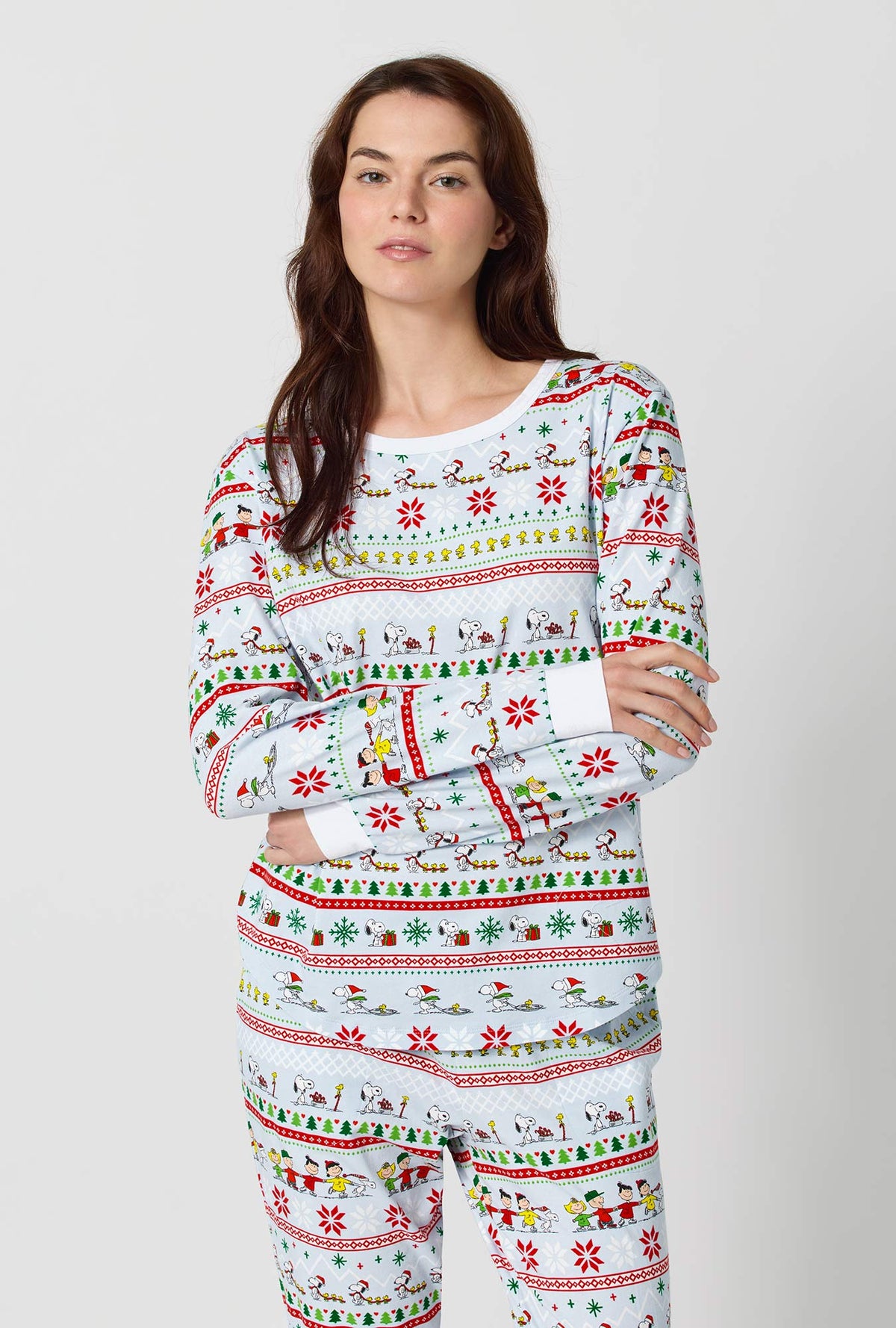 A lady wearing Peanuts® Winter Parade Long Sleeve Pullover Crew And Jogger Stretch Jersey Pj Set closer look