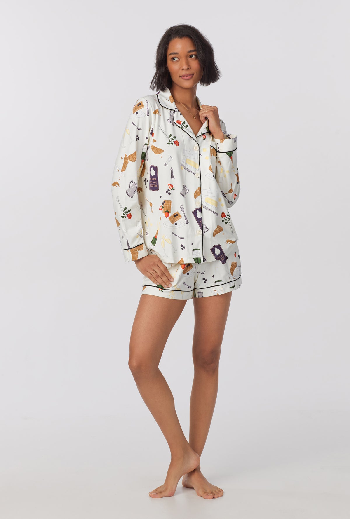 A lady wearing Long Sleeve Classic Stretch Jersey Short PJ Set with breakfast in bed print