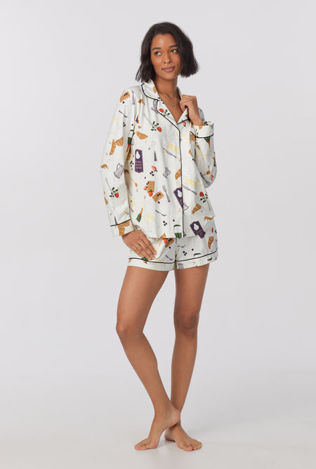 A lady wearing Long Sleeve Classic Stretch Jersey Short PJ Set with breakfast in bed print