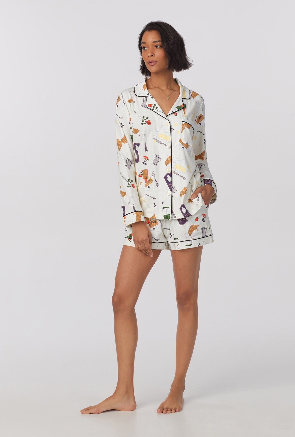 A lady wearing Long Sleeve Classic Stretch Jersey Short PJ Set with breakfast in bed print