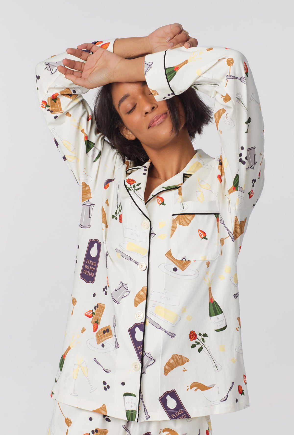 A lady wearing Long Sleeve Classic Stretch Jersey Short PJ Set with breakfast in bed print