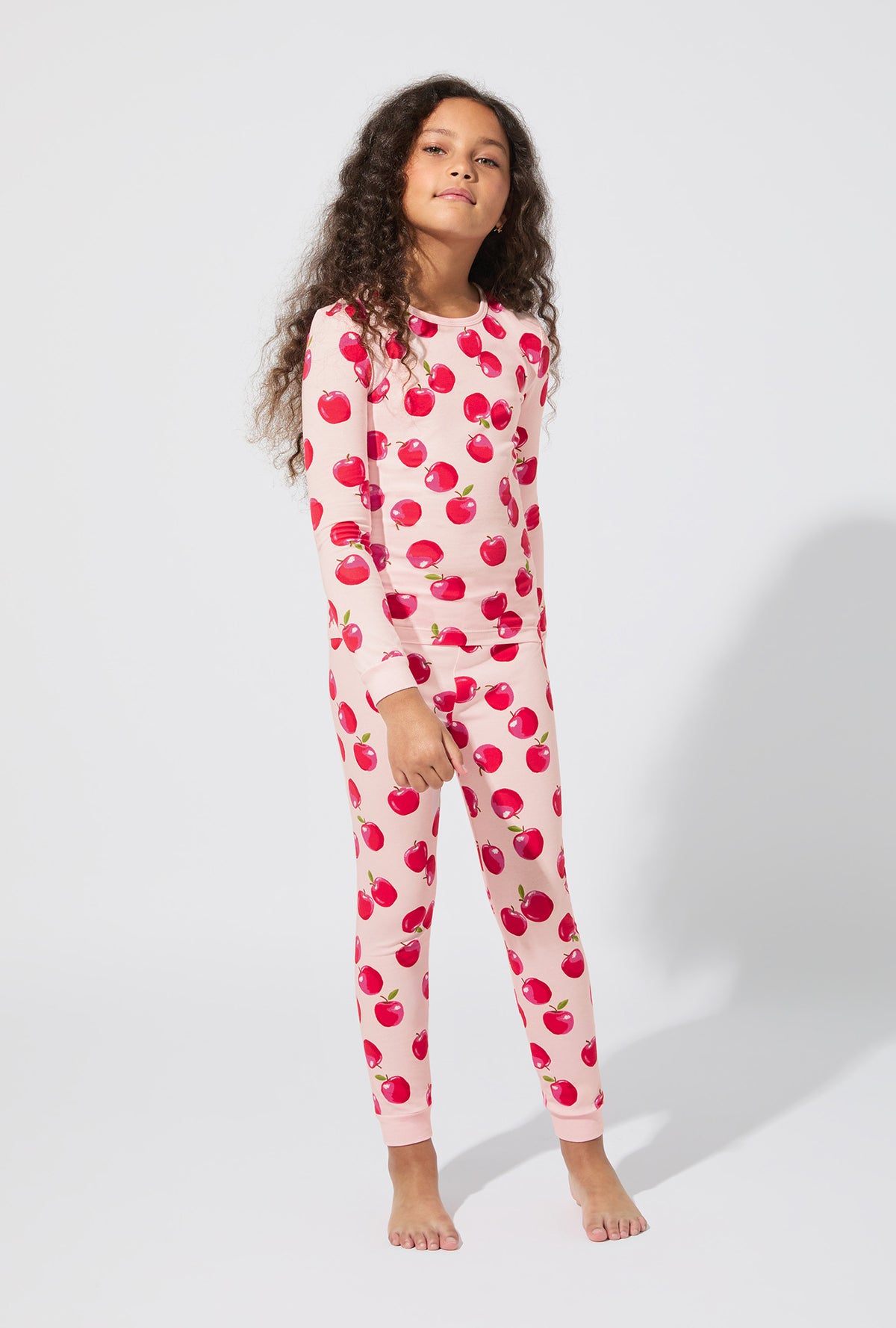 A girl wearing An Apple A Day Long Sleeve Stretch Jersey Kids PJ Set